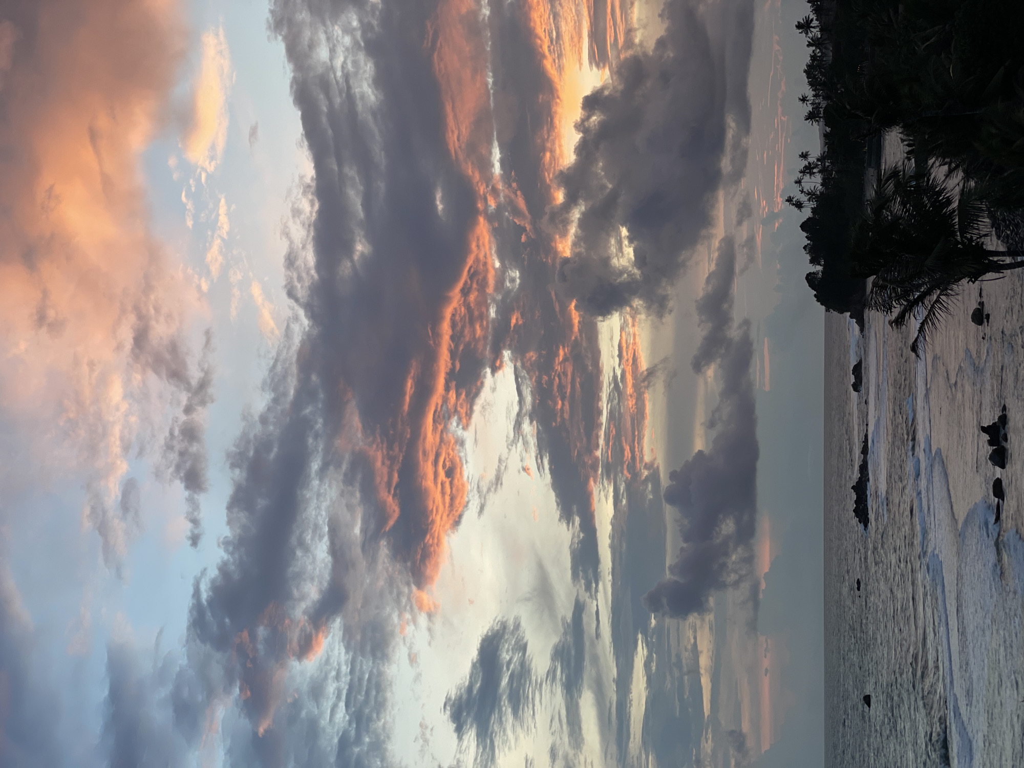 Dramatic sunset illuminates cloudy sky over Goviyapana coast