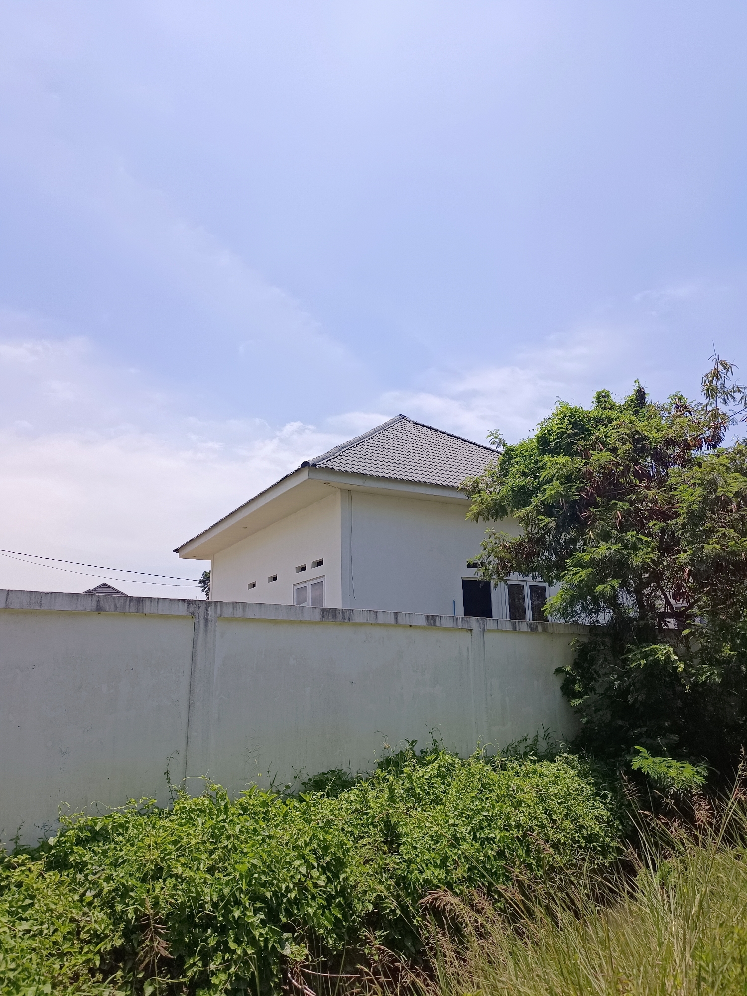 Rural white house with dirt path, Meunasah Raya, Indonesia