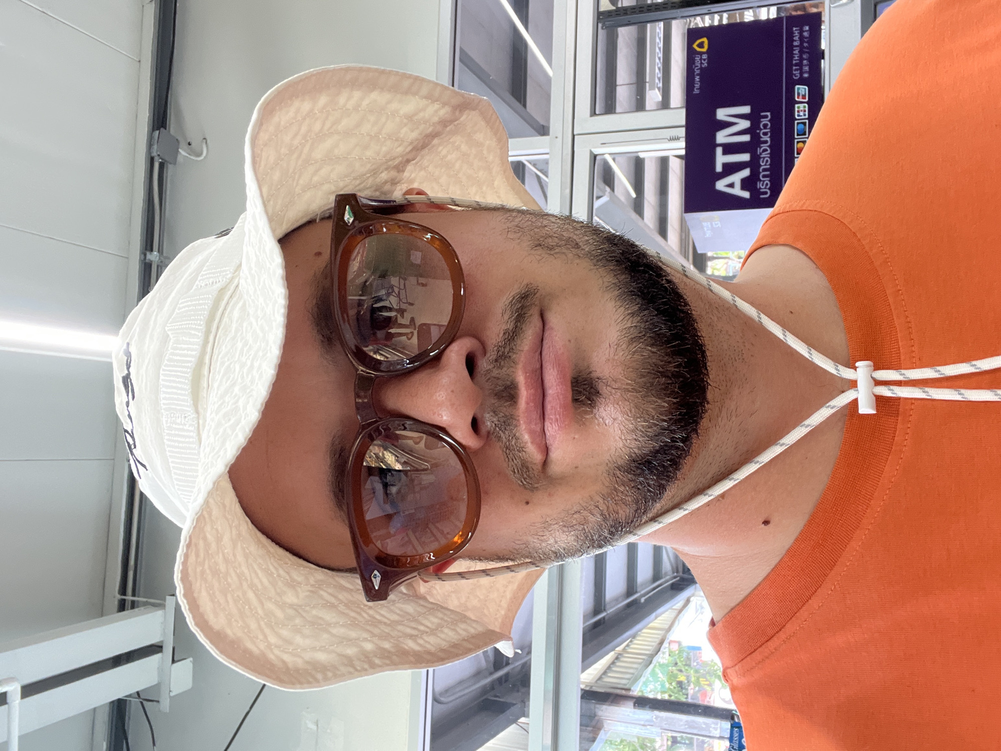 Man in orange shirt observed inside commercial building