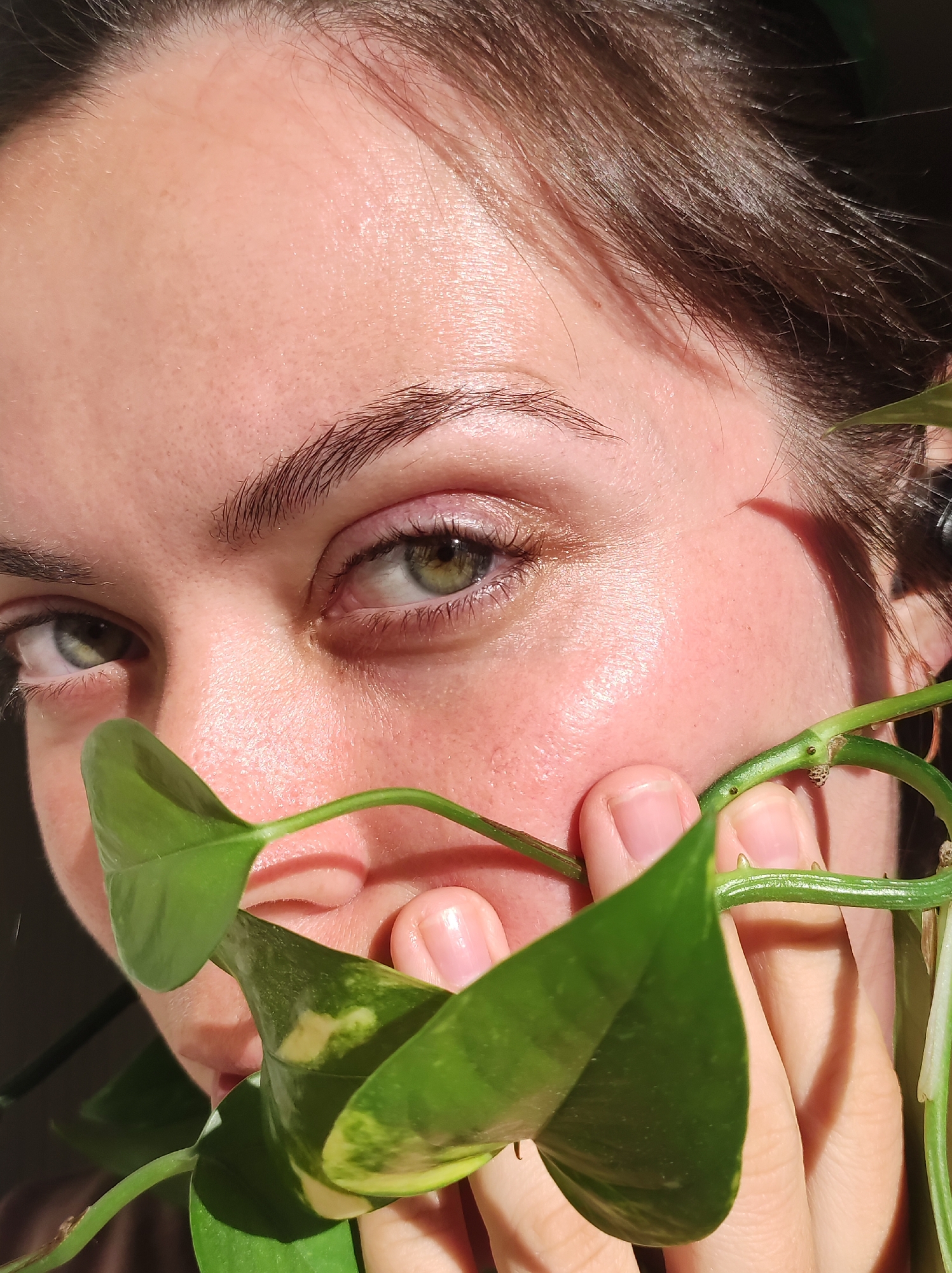 Portrait session captured in natural sunlight with green vegetation