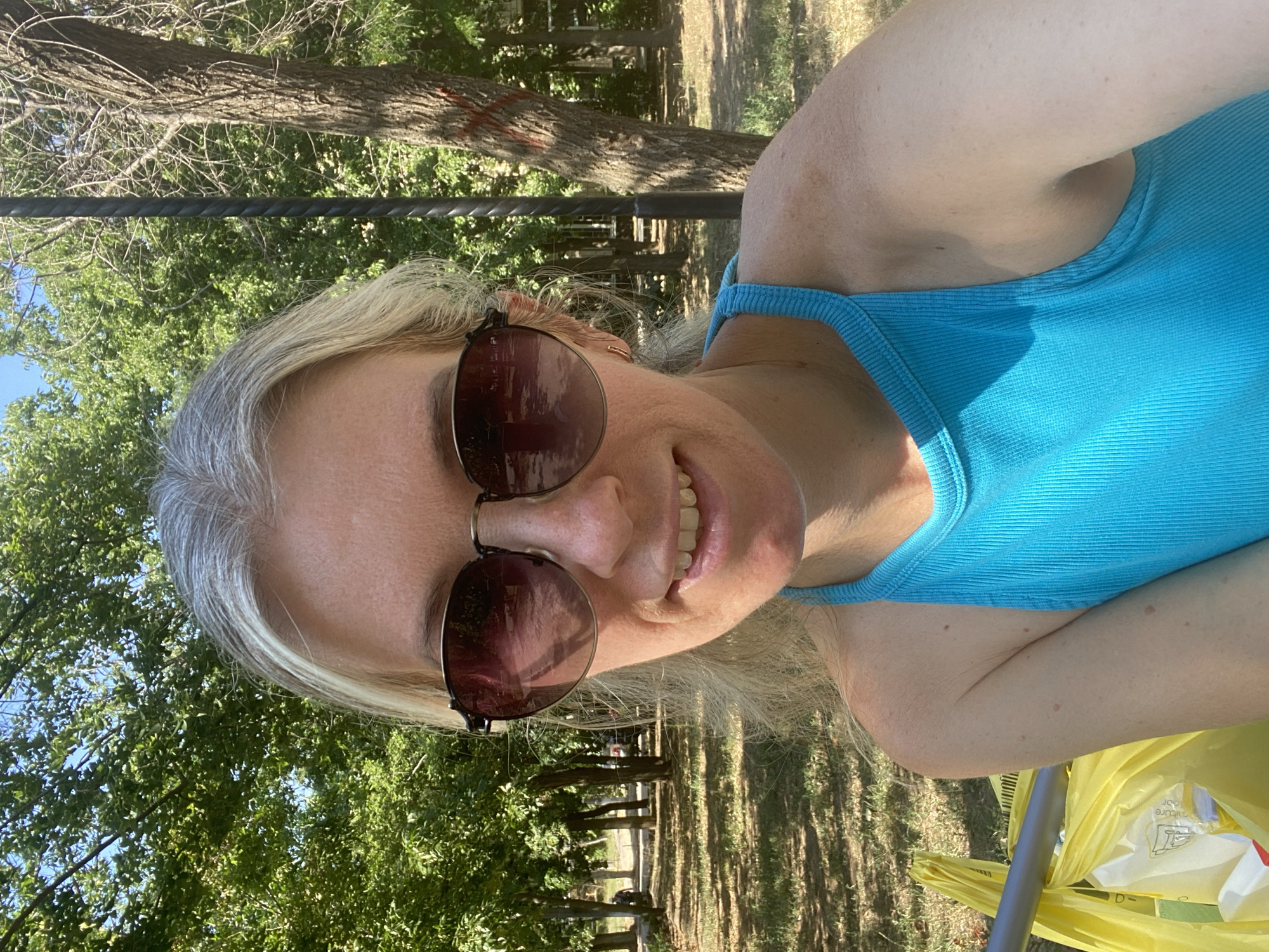 Sunny park moment: selfies, pigeons, and a stroller passing through