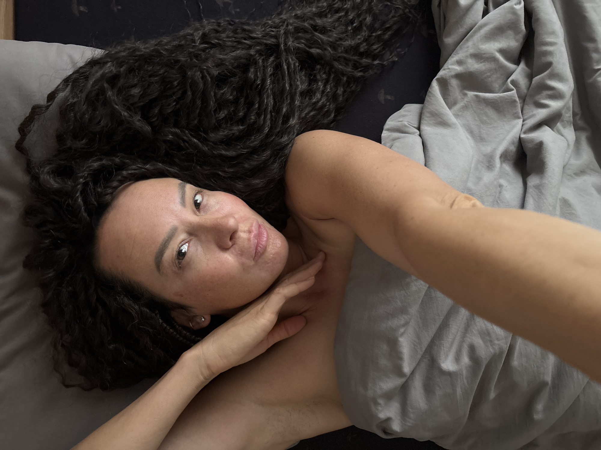 Woman rests in bed during early morning hours in Chaikovsky