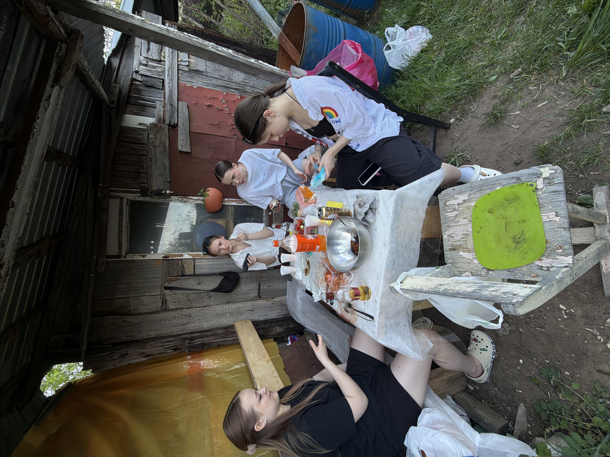 Friends enjoy springtime barbecue and gardening in Perm backyard