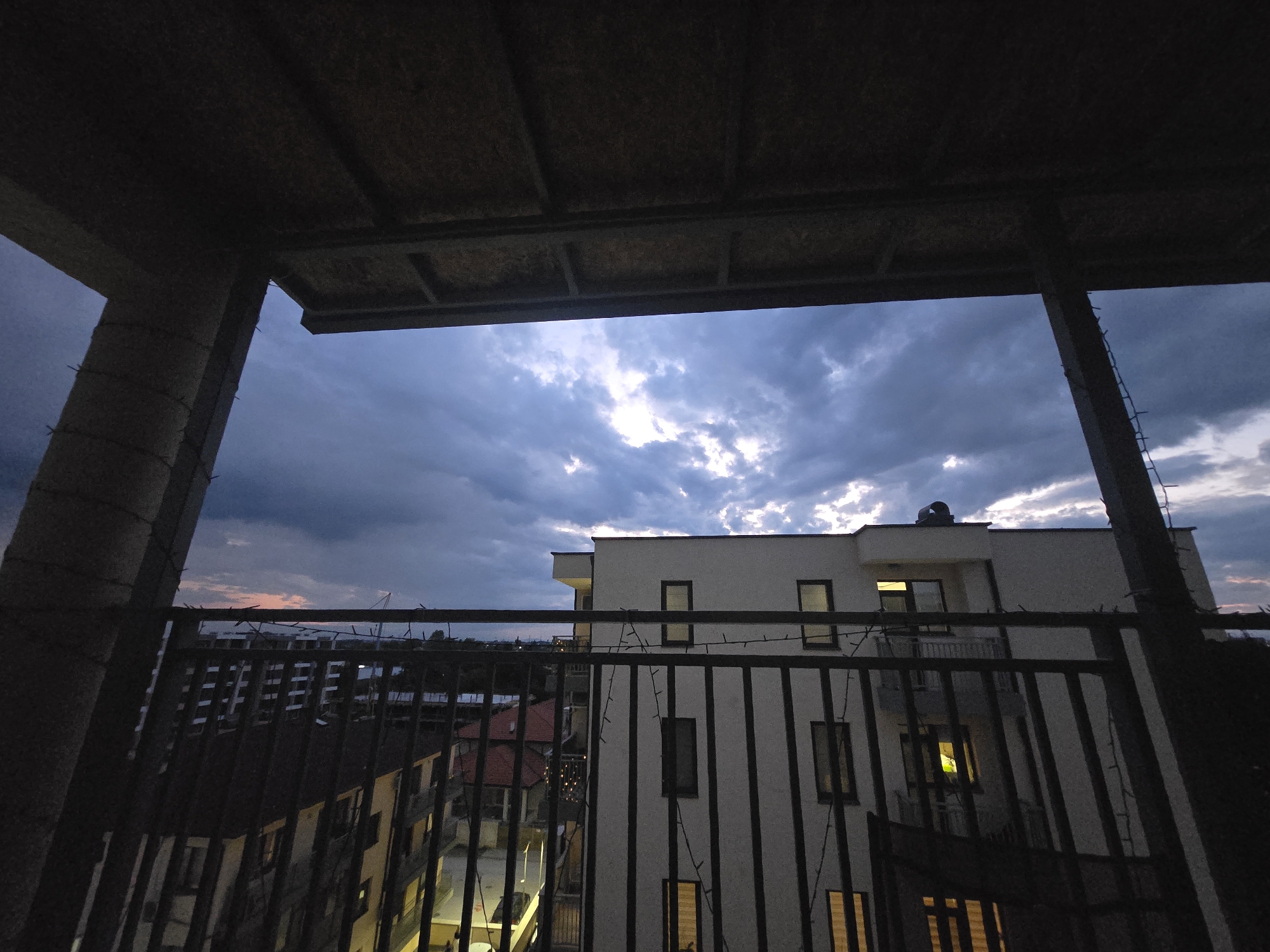 Evening barbecue observed from urban balcony at dusk
