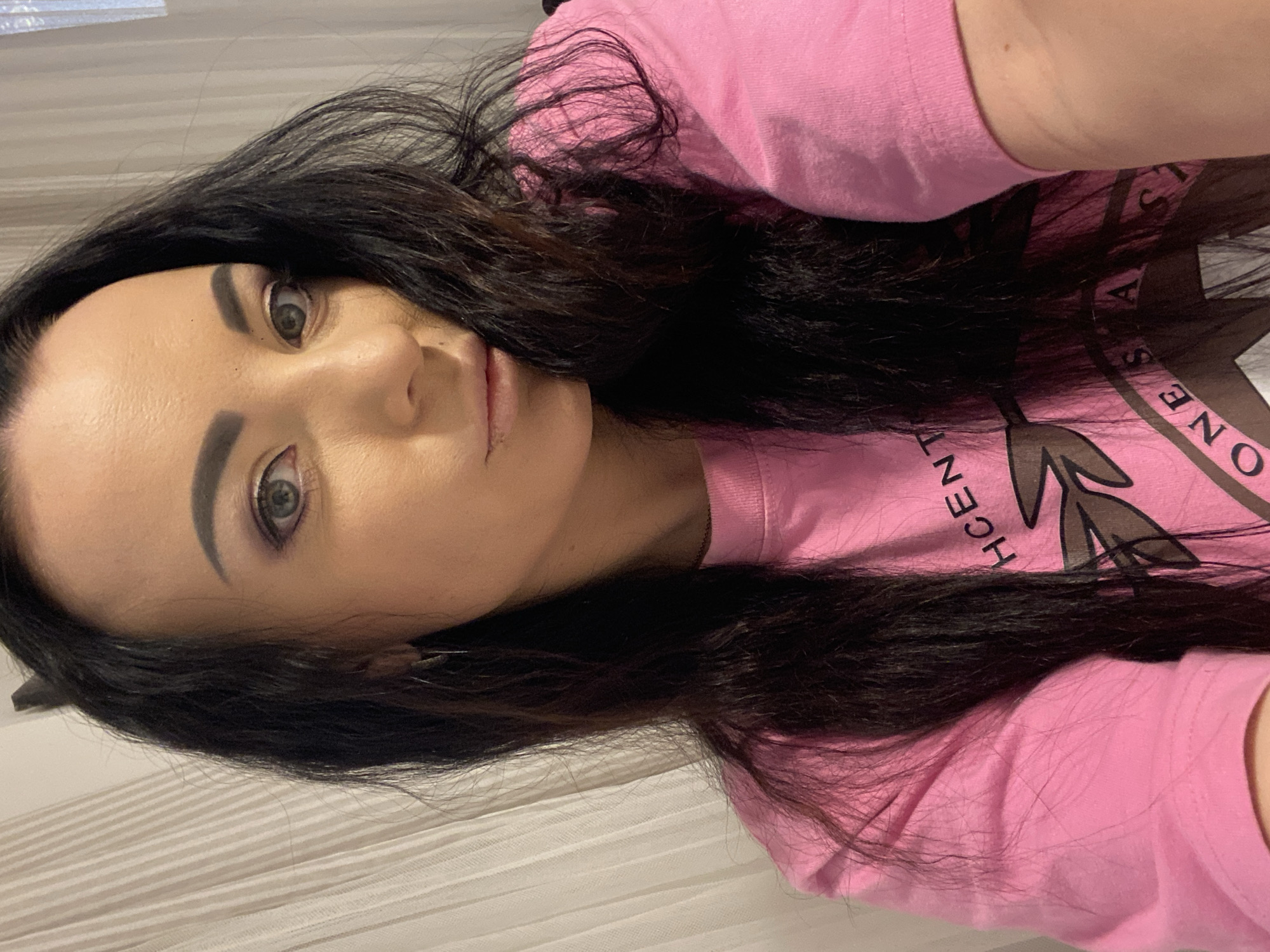Indoor selfie showing a bold pink graphic tee in Sharm El Sheikh