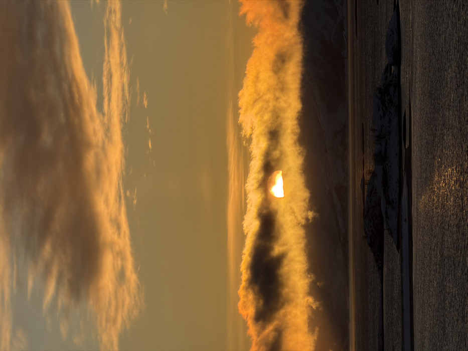 Arctic sunset illuminates snow-covered islands near Tromsø, Norway