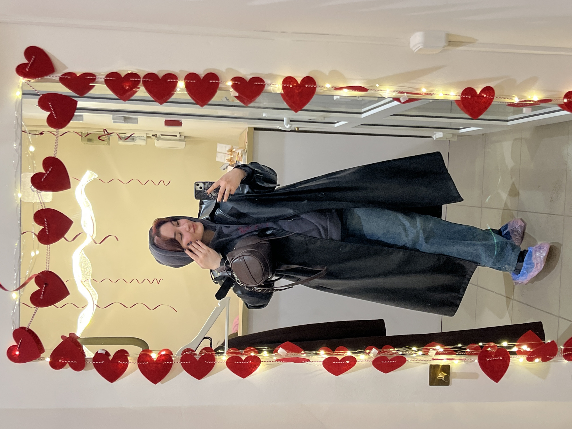 Person poses in heart-decorated room in Neftekamsk