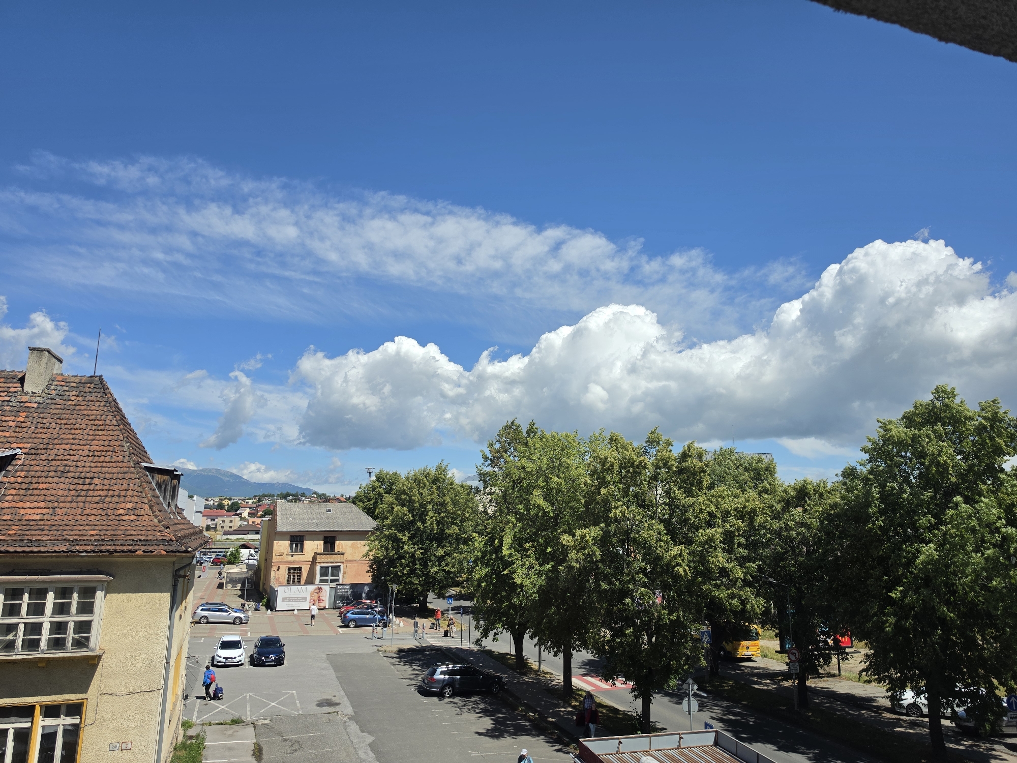 Street-level and aerial views on a clear summer morning