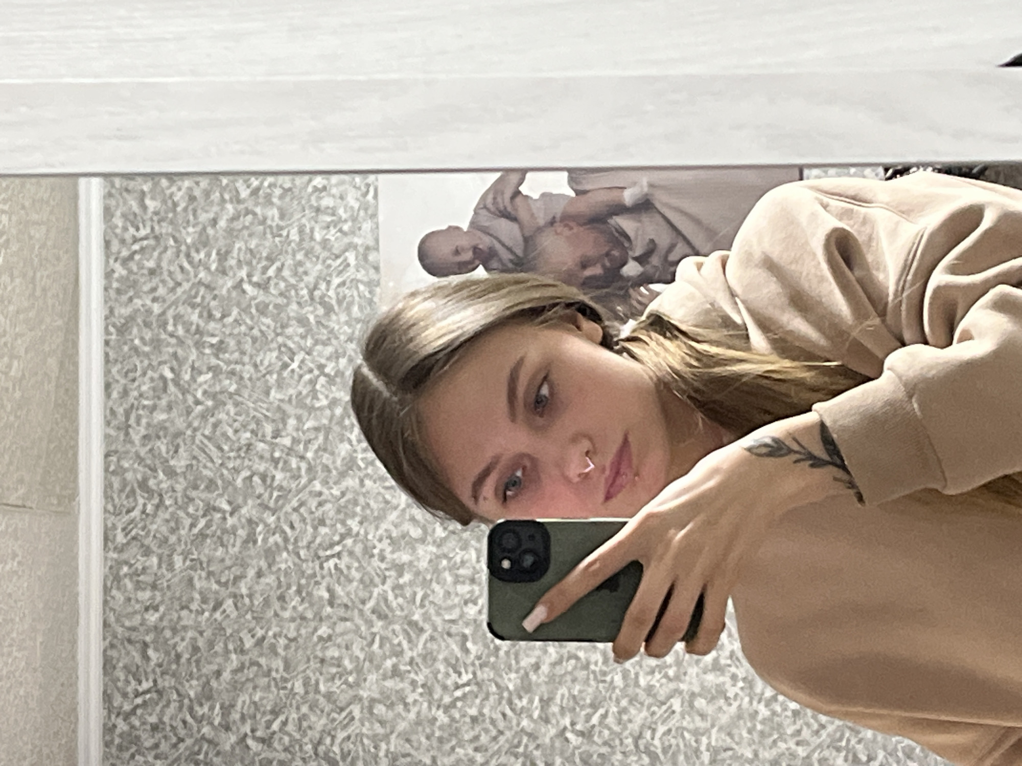 Woman takes bathroom mirror selfie in Foki, Russia
