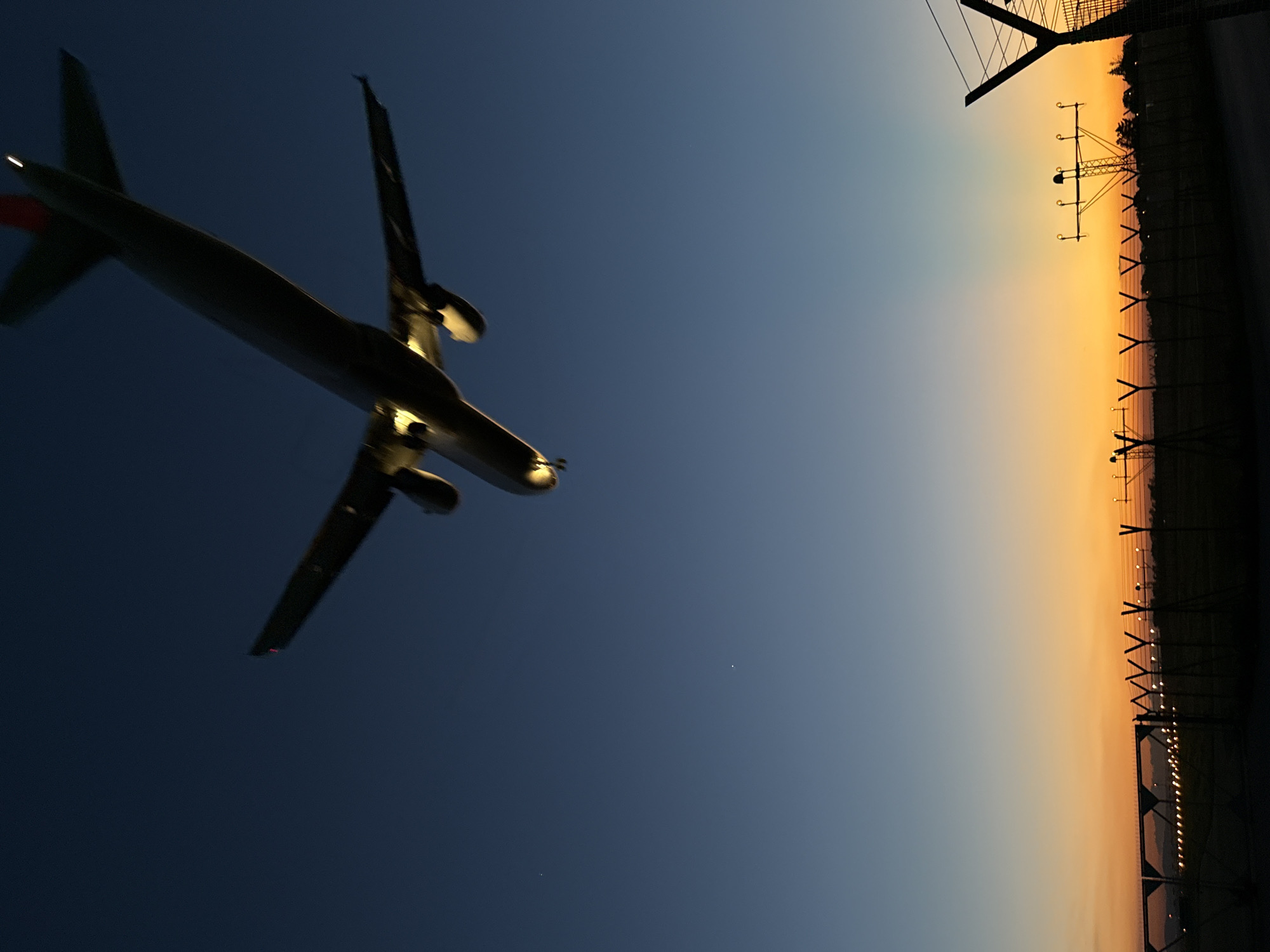 Aircraft lands at Sofia airport during sunset twilight