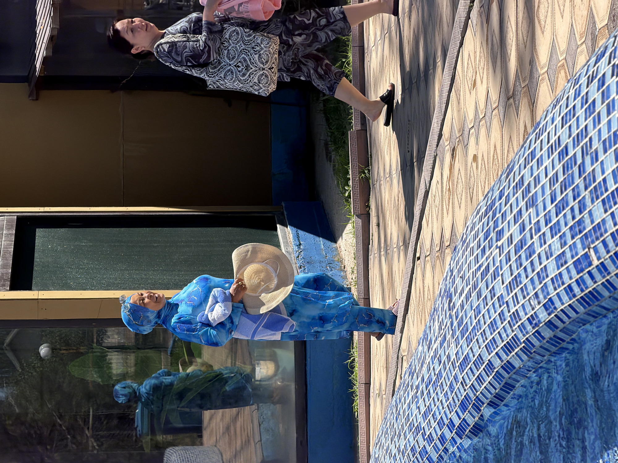 Sunny poolside hangout with swimming, wading, and poolside strolls