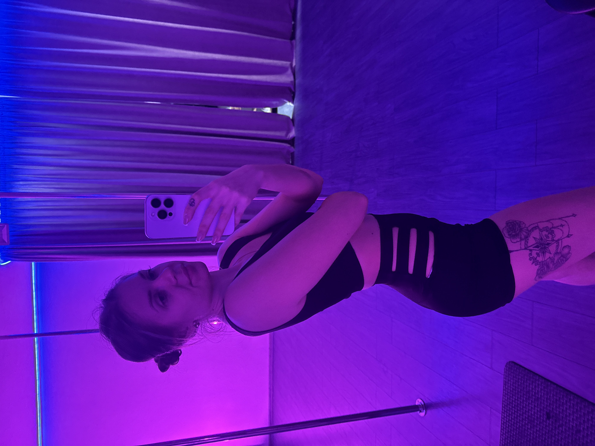 Pole fitness session documented in purple-lit Batumi studio