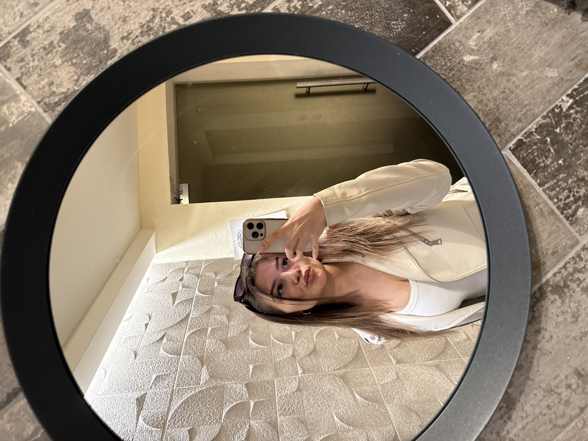 Woman takes selfie in round mirror in Sofia