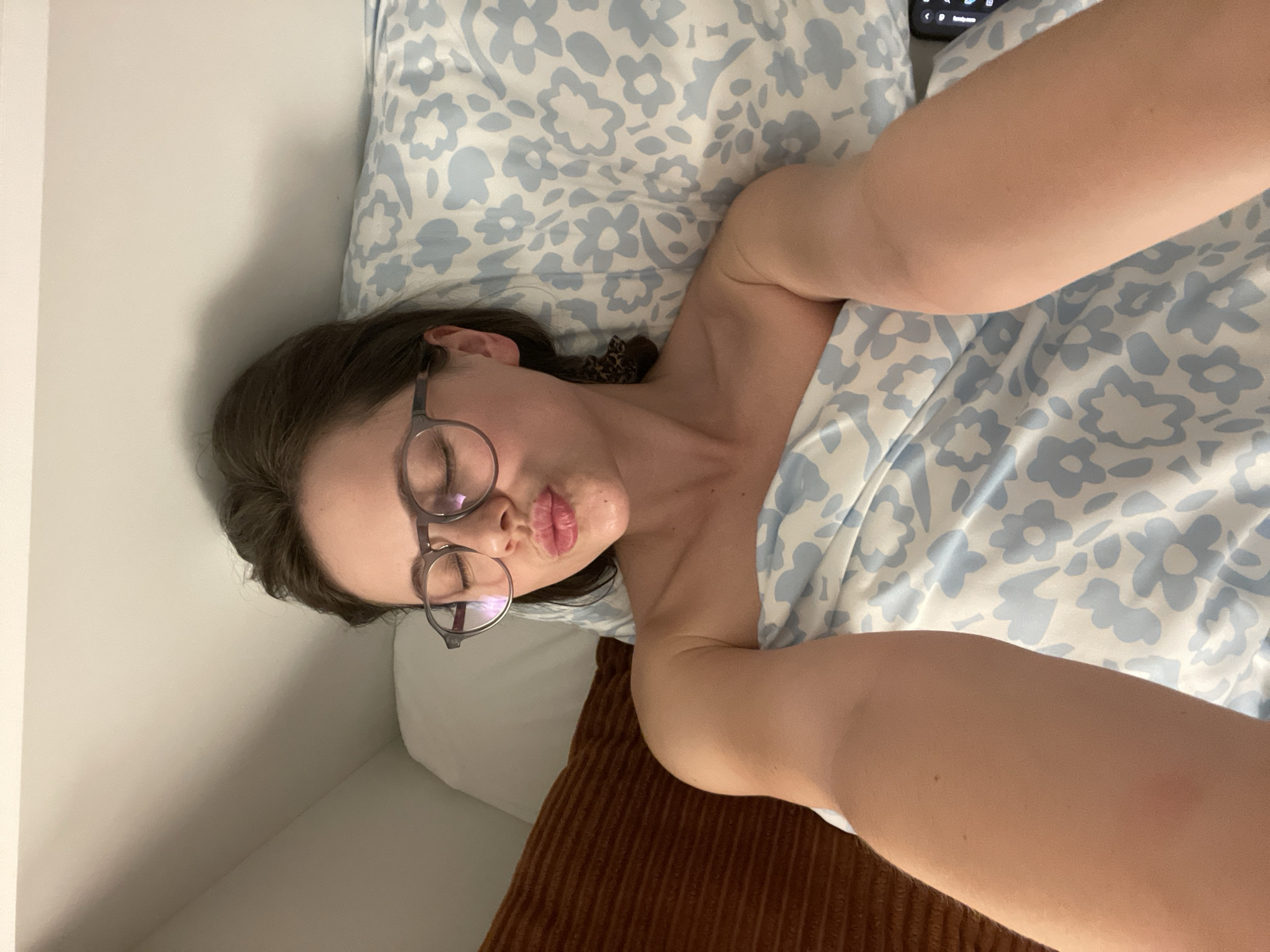 Woman rests in bed in Budapest apartment