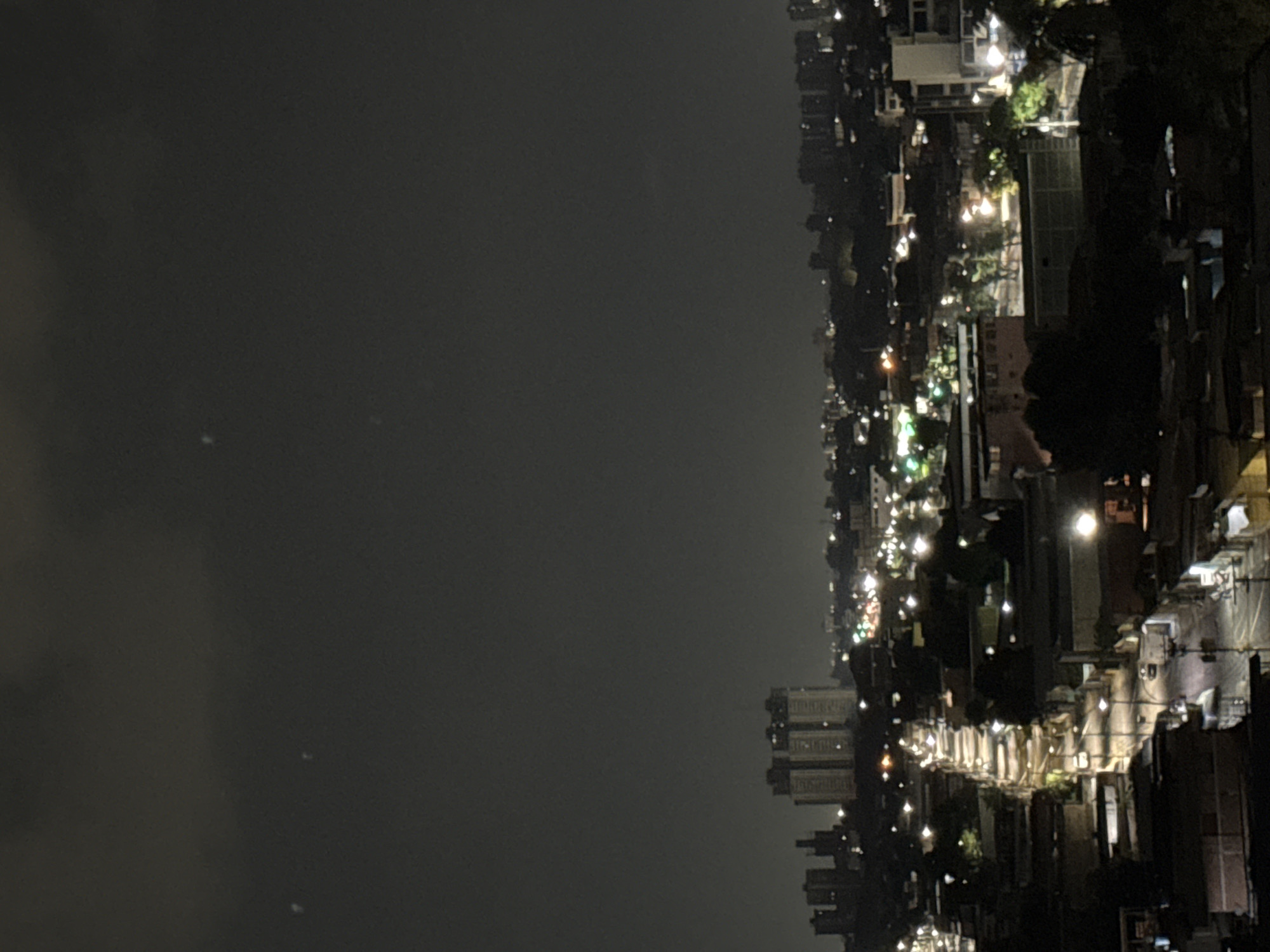 Nighttime cityscape captured in Maracay, Venezuela under overcast skies