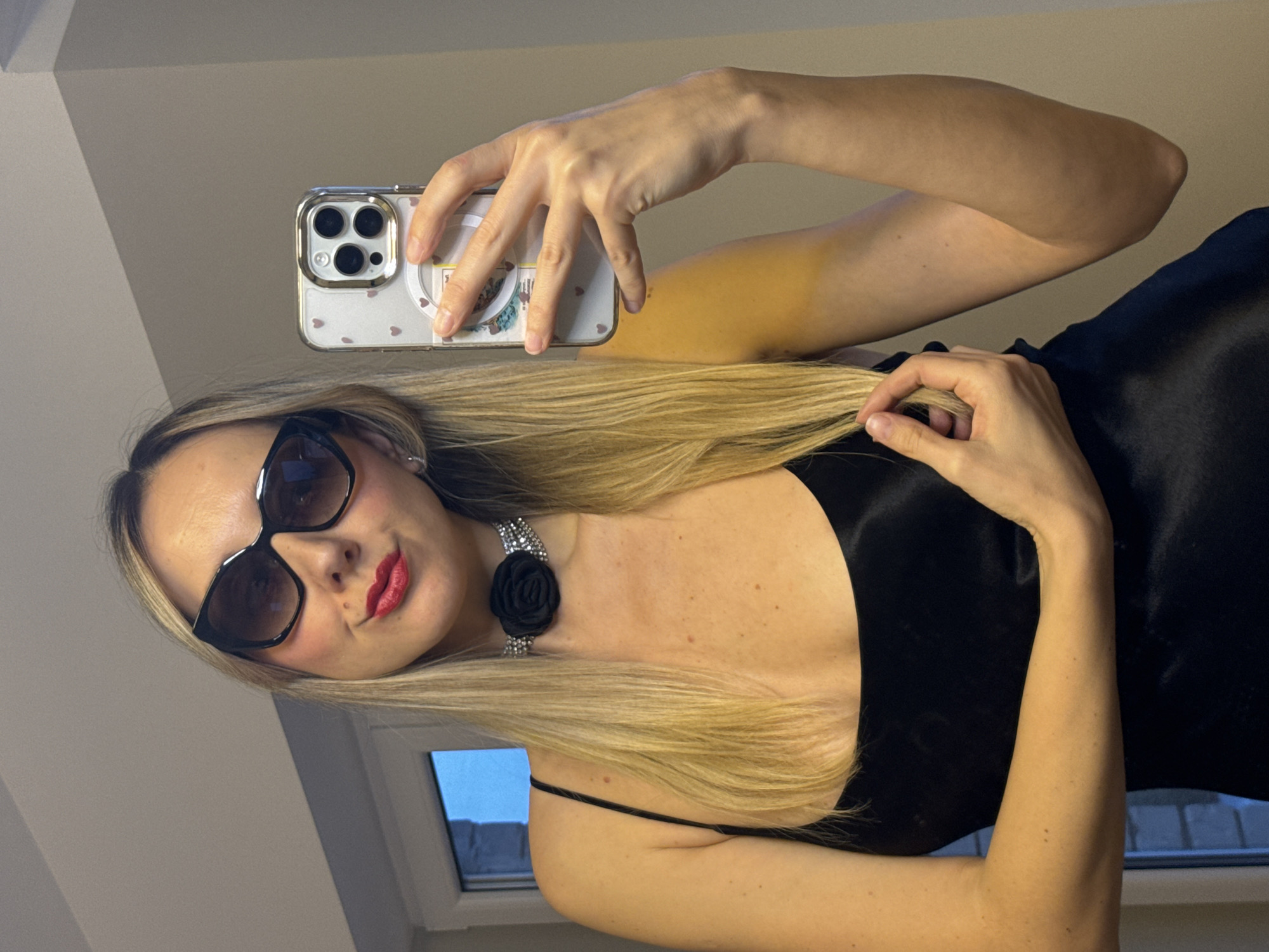 Woman takes wine selfies in room with fish tank