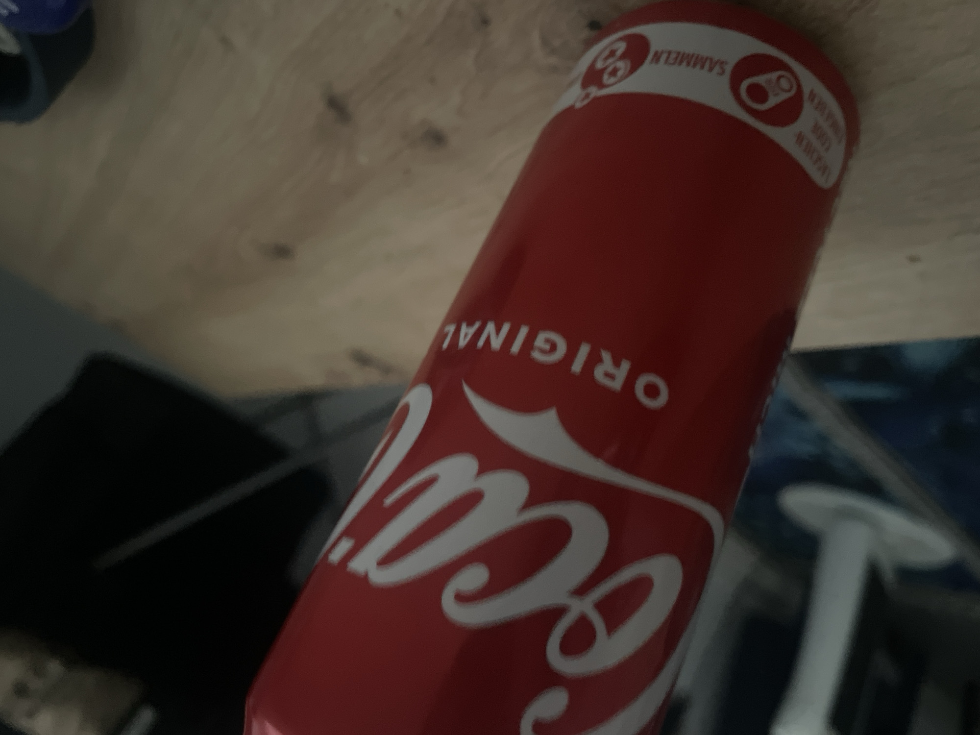 Coca-Cola can spotted on wooden surface in Mannheim