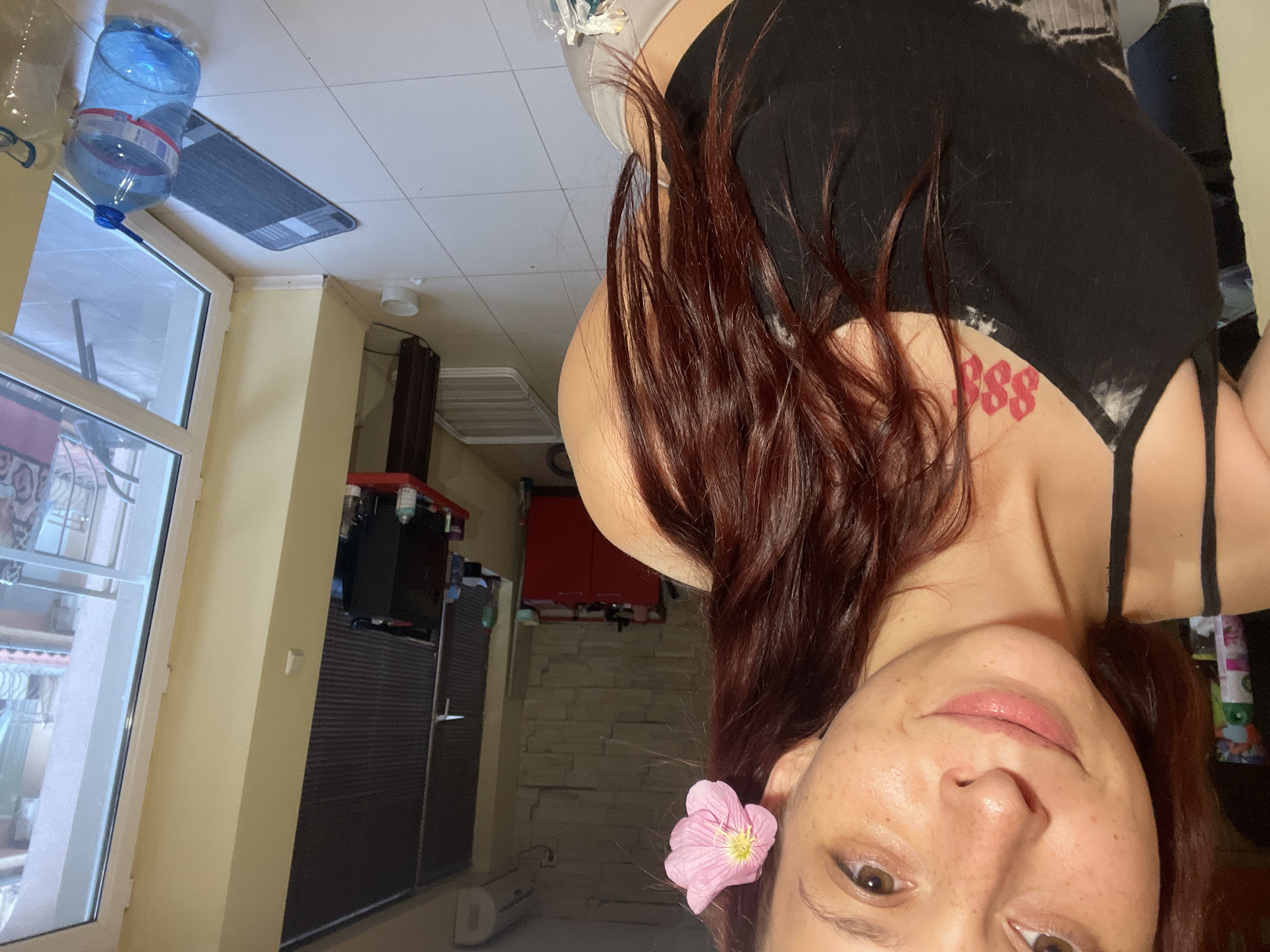 Two angles: pink flower, tie-dye top, Nesebar coastline