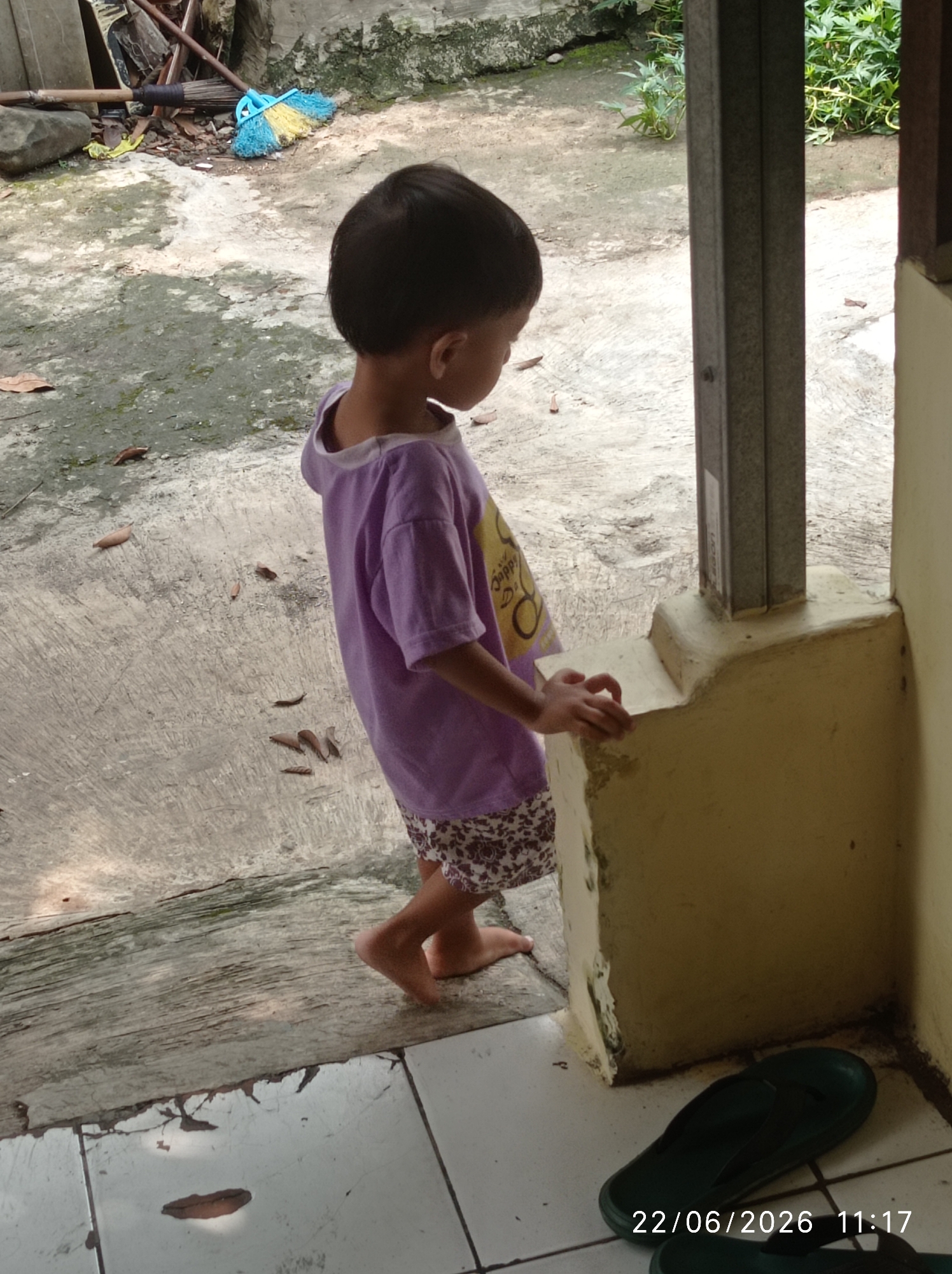 Toddler and tabby cat share a quiet morning in Sukaraja