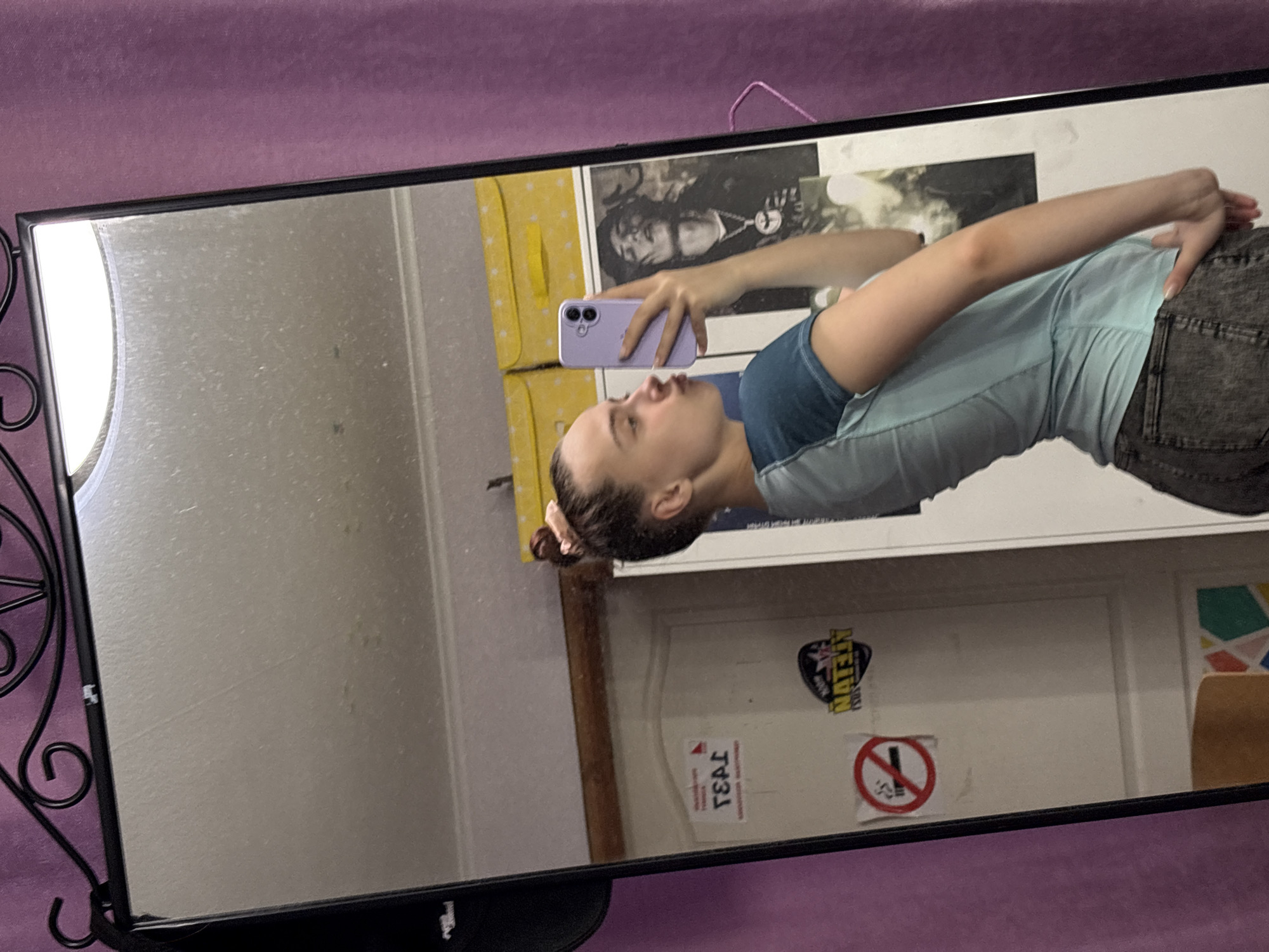 Person takes mirror selfie with purple phone in Russia