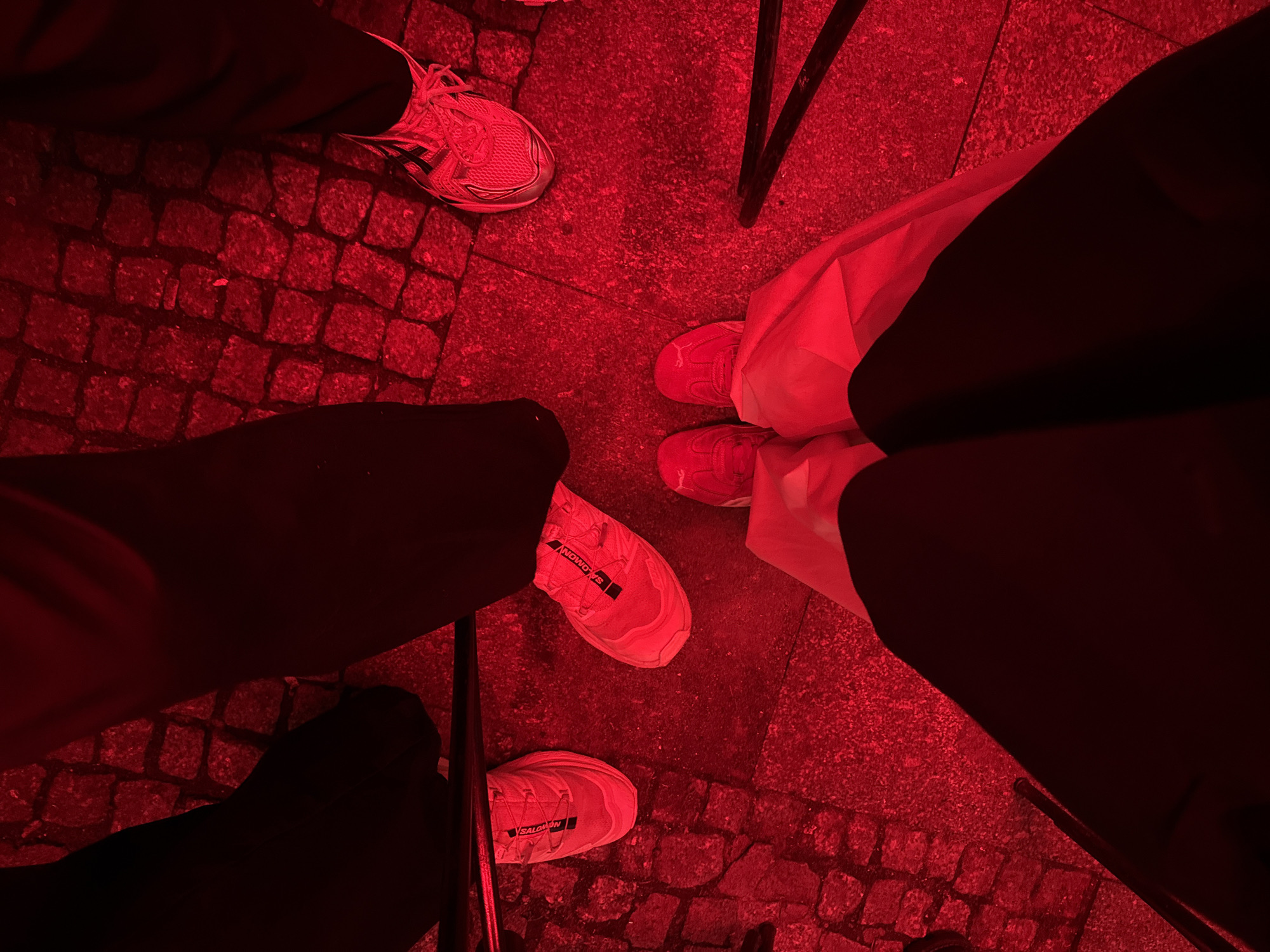 Red-lit nighttime gathering documented across multiple indoor-outdoor venues