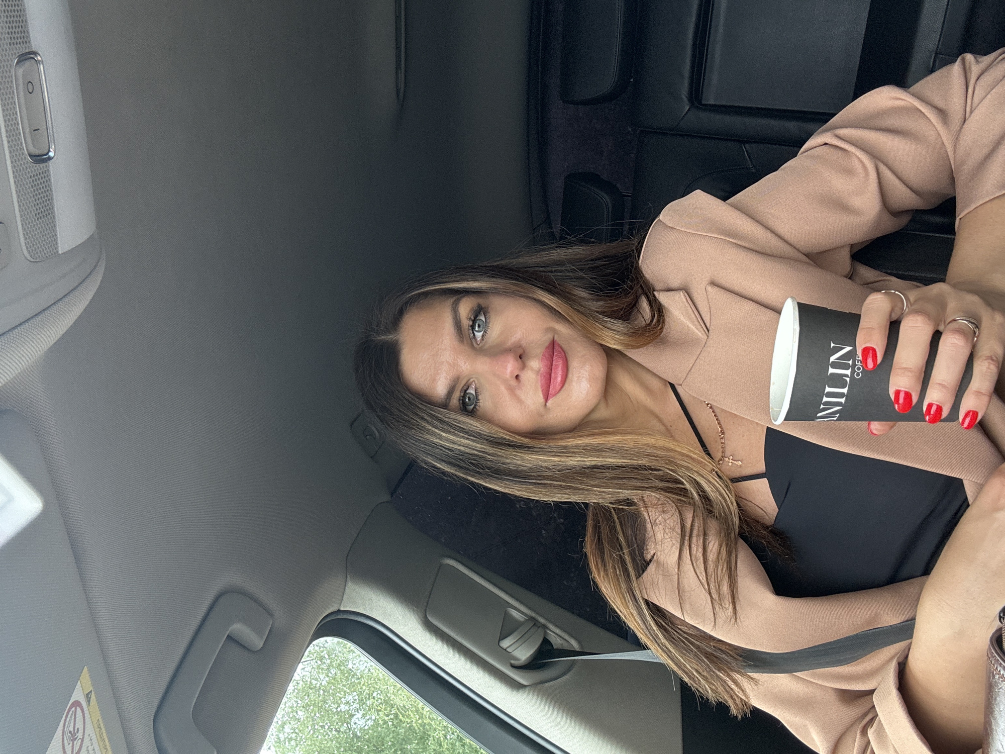Woman takes selfies in car near water in Chaikovsky