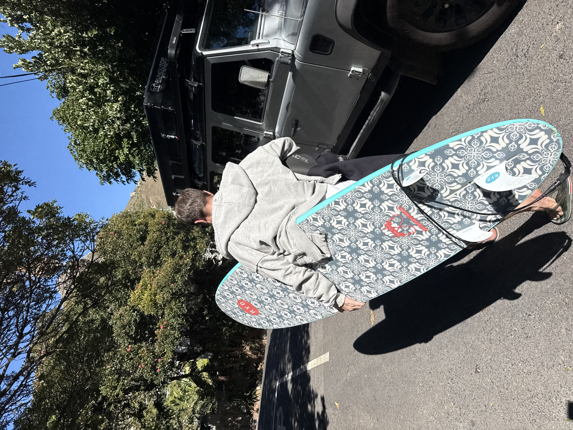 Surfer loads equipment at Hout Bay parking area