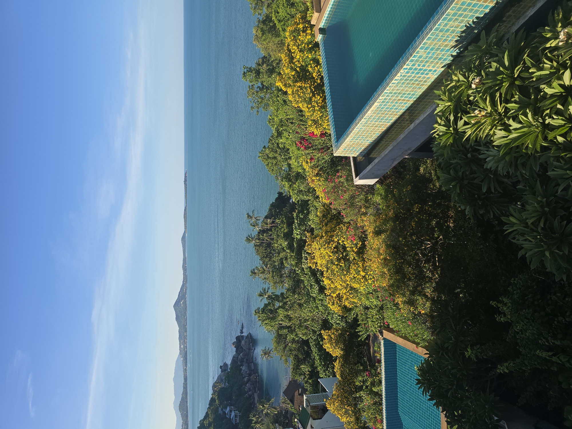 Tropical hillside resort views mixed with busy street-level scooter traffic