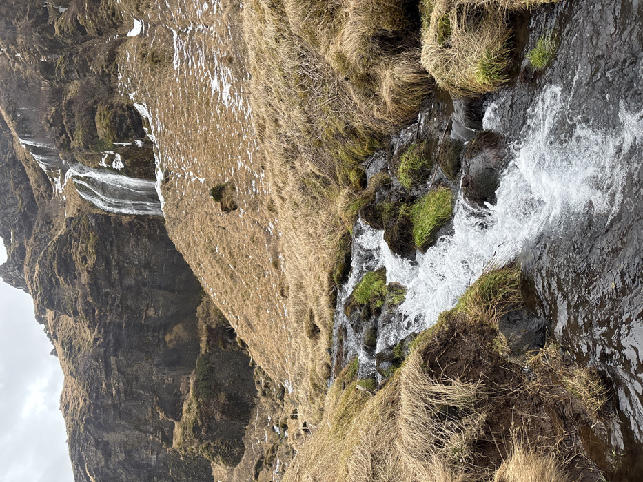 Winter waterfall landscapes documented in Iceland under grey skies