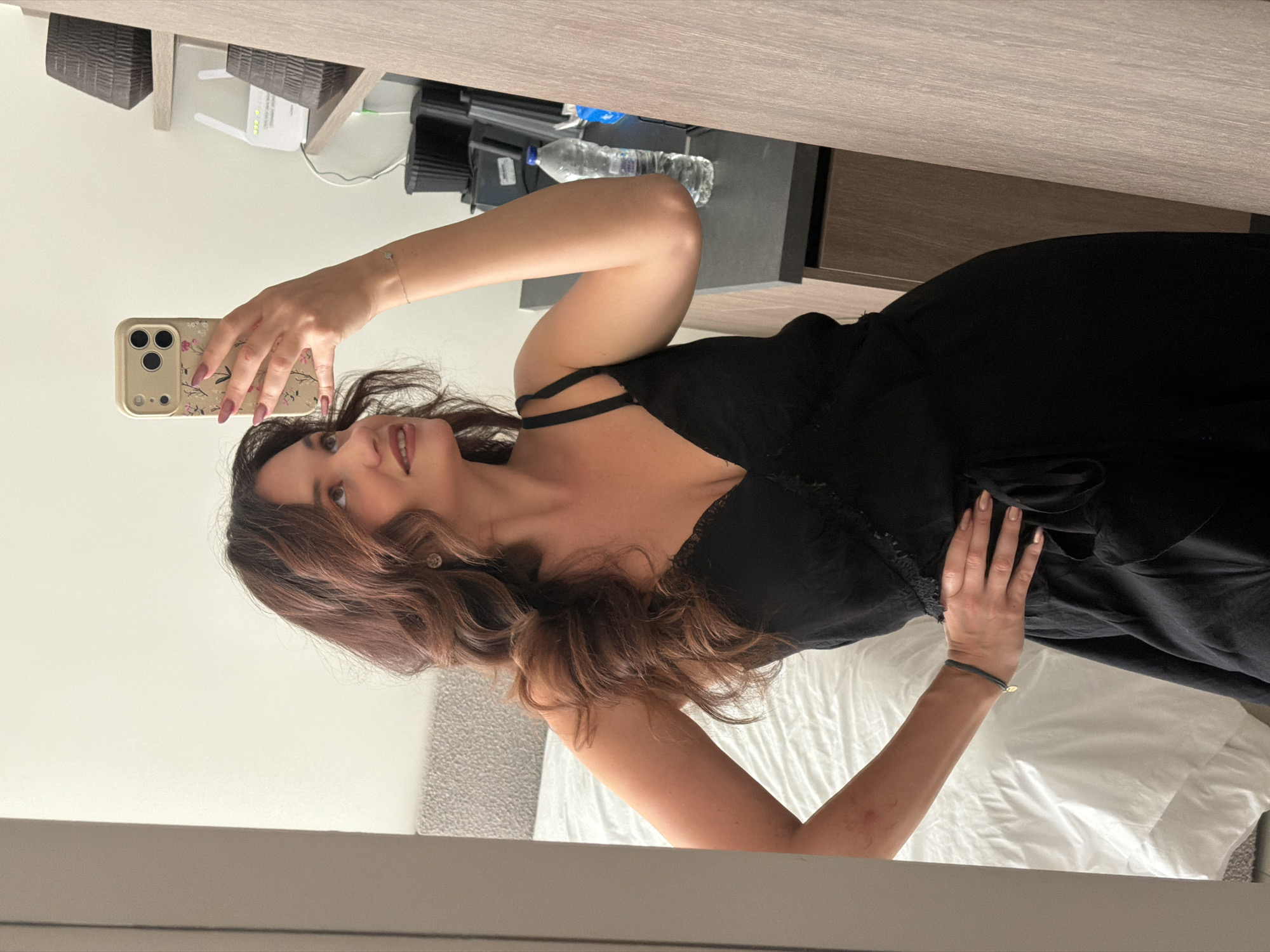 Woman in black dress photographed indoors in Athens