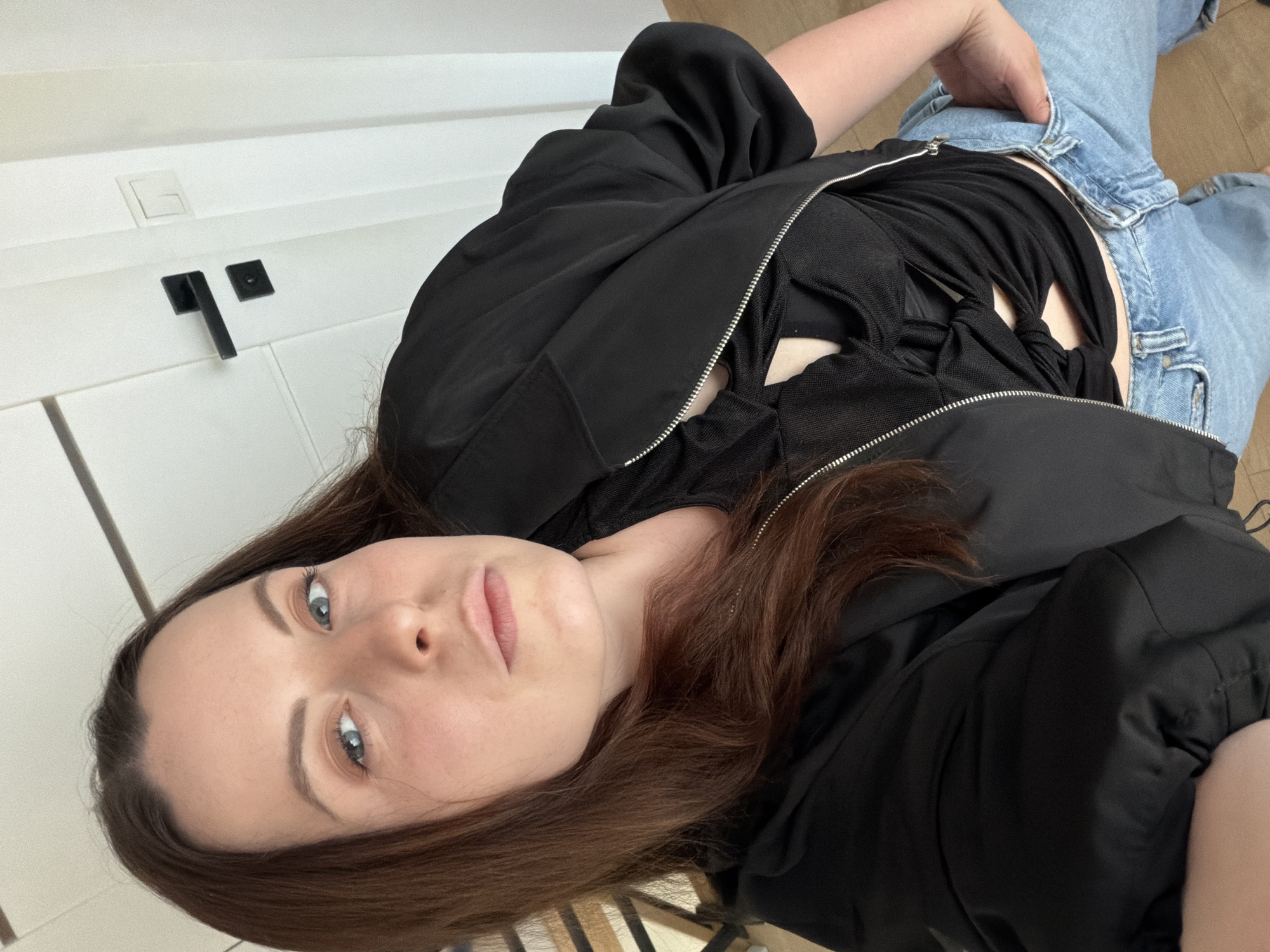 Woman takes mirror selfies in German home