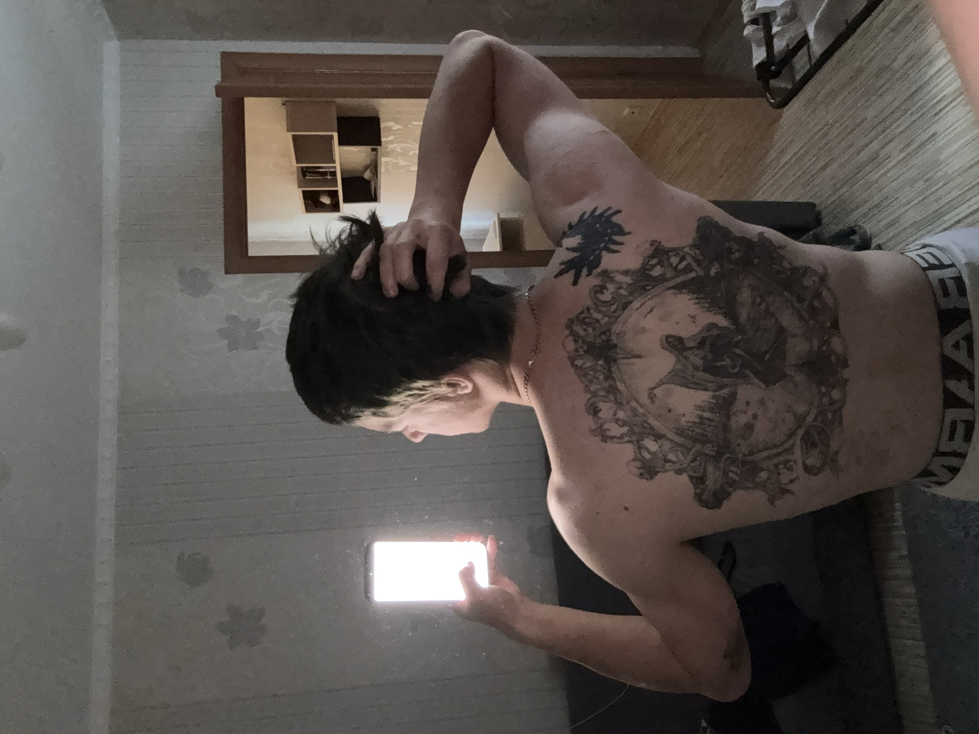 Tattooed leg, fake lavender, phone — casual home shoot in Minsk