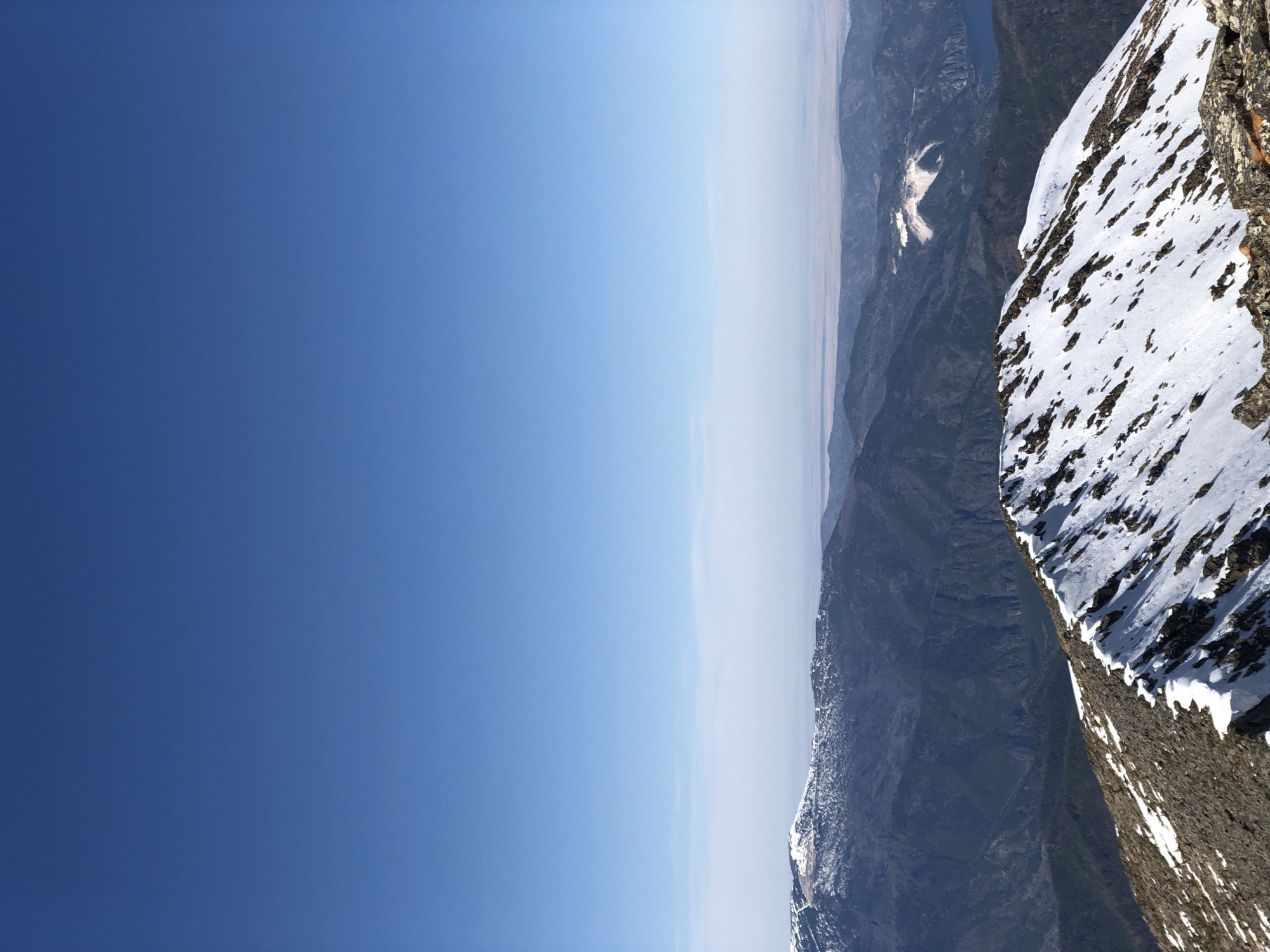 Snow-covered mountain slopes observed under clear skies in Sayanogorsk