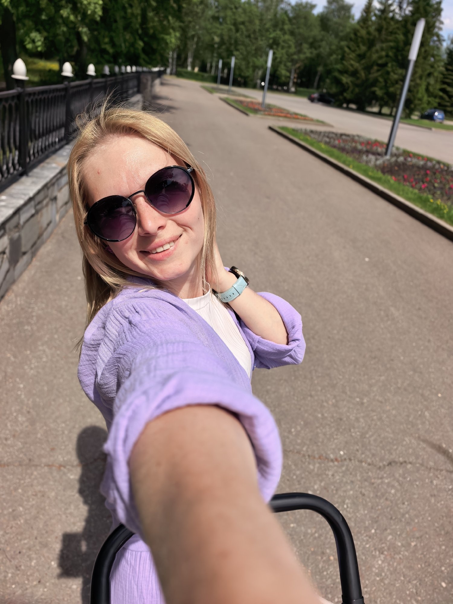 Woman takes selfies in Sterlitamak park on sunny morning