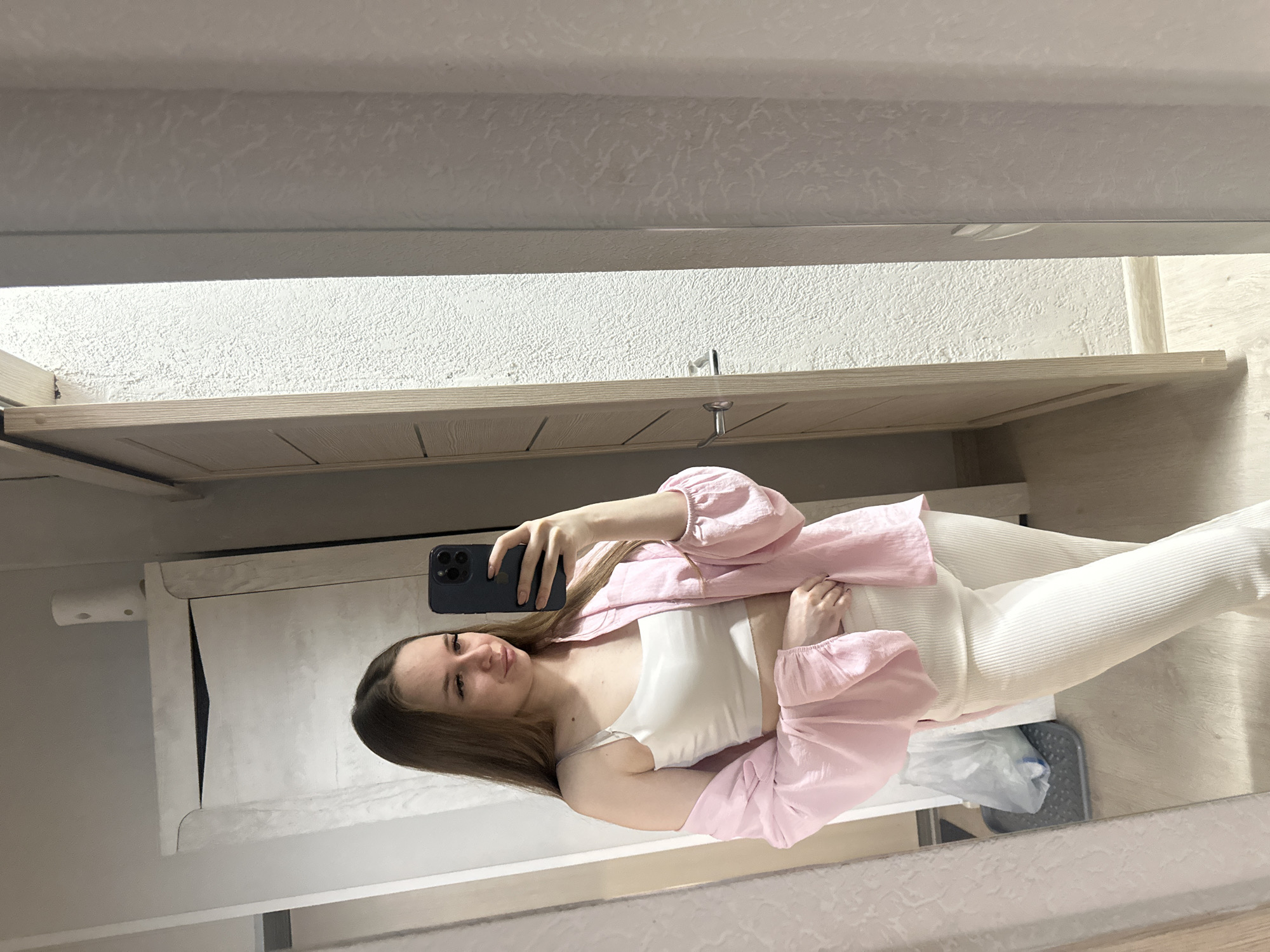 Woman takes multiple mirror selfies indoors during 44-minute session