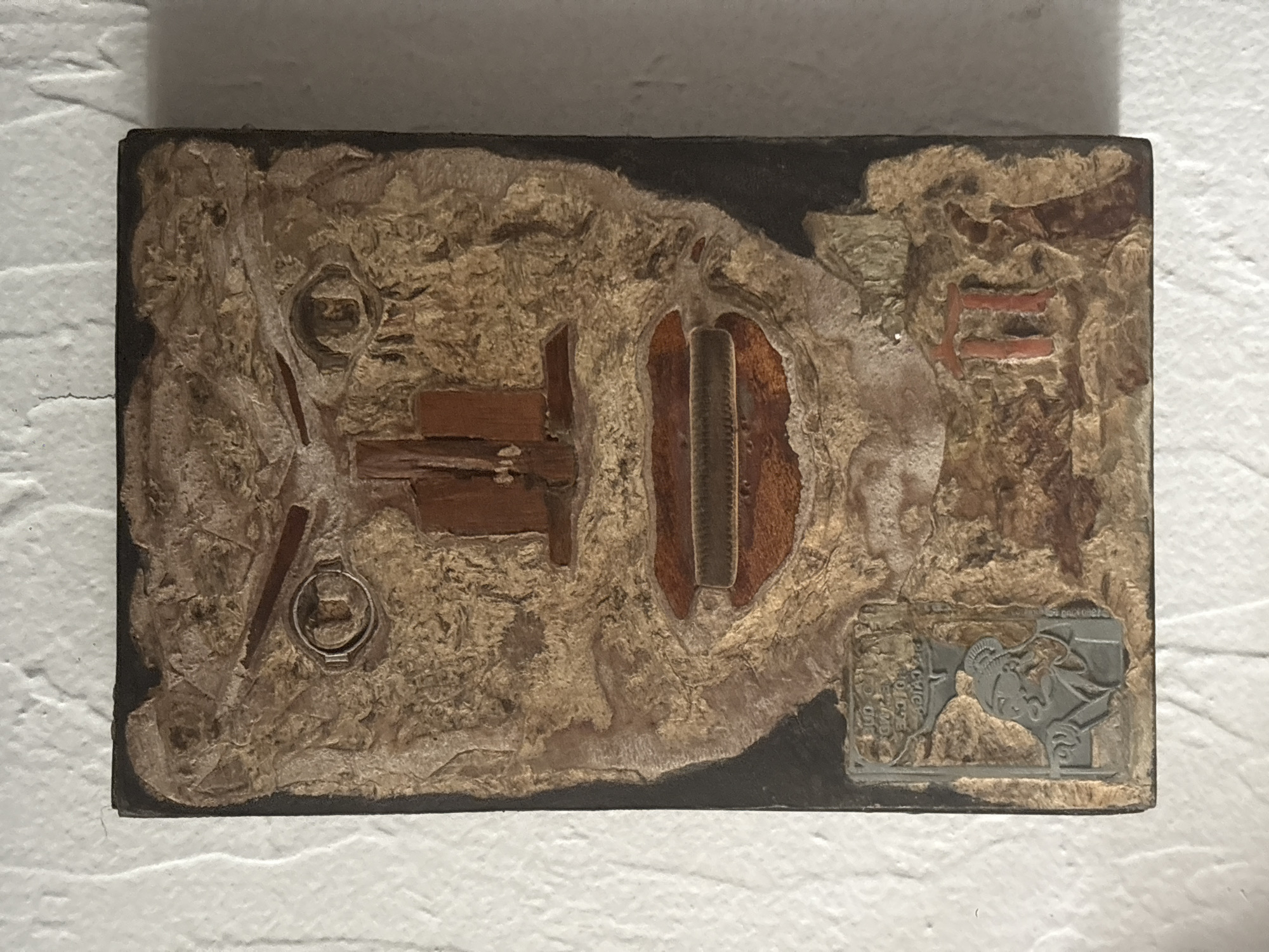 Mixed-media artwork observed on textured wall in Mexico City