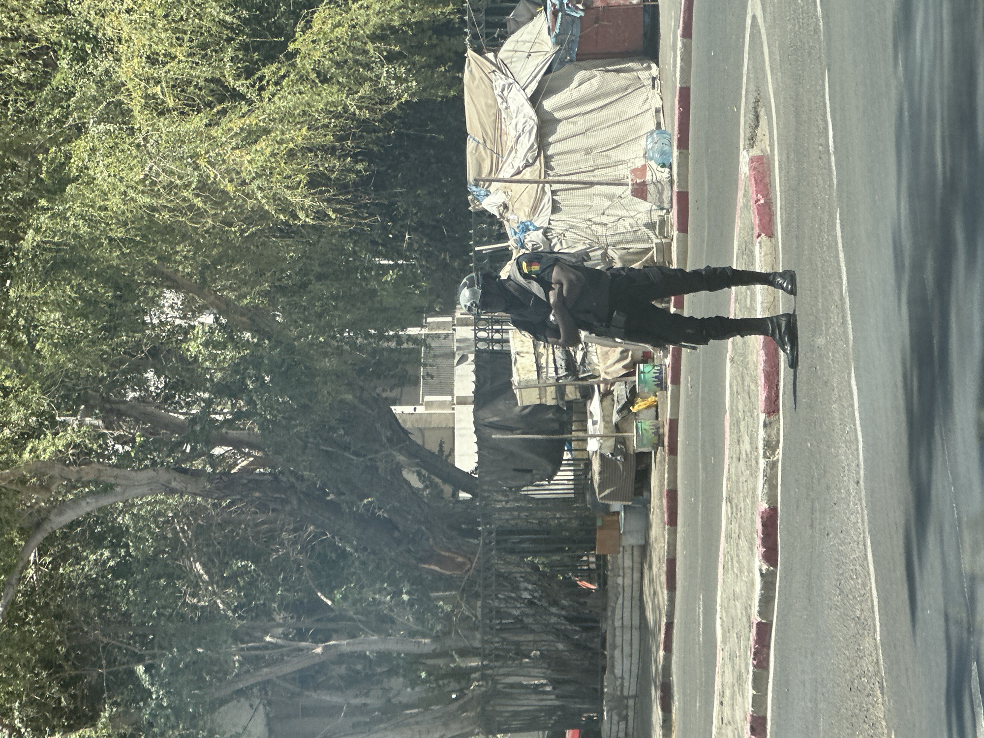 Dakar street scenes captured showing uniformed person, yellow taxi