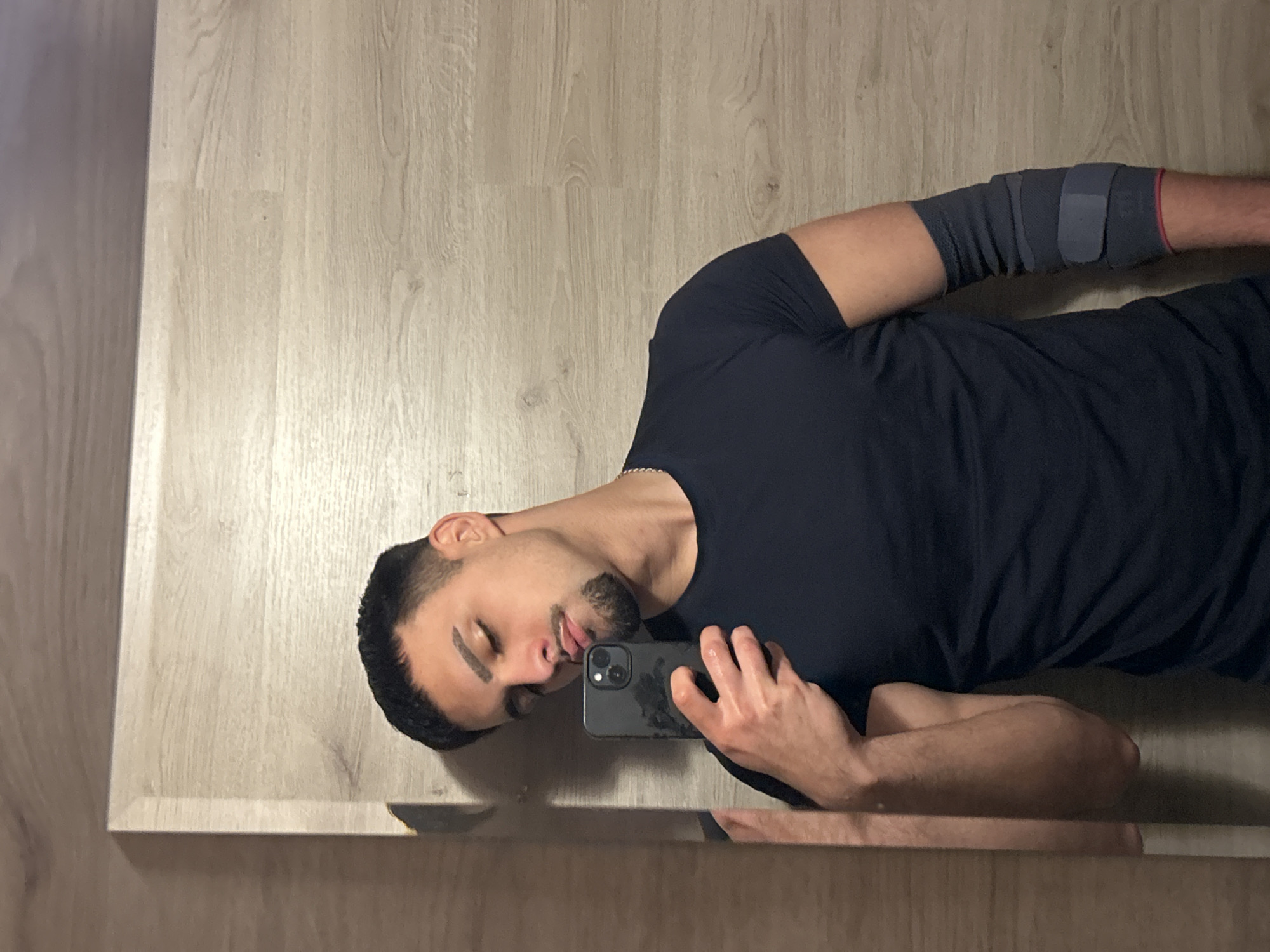 Man with elbow brace uses phone while resting in Sofia