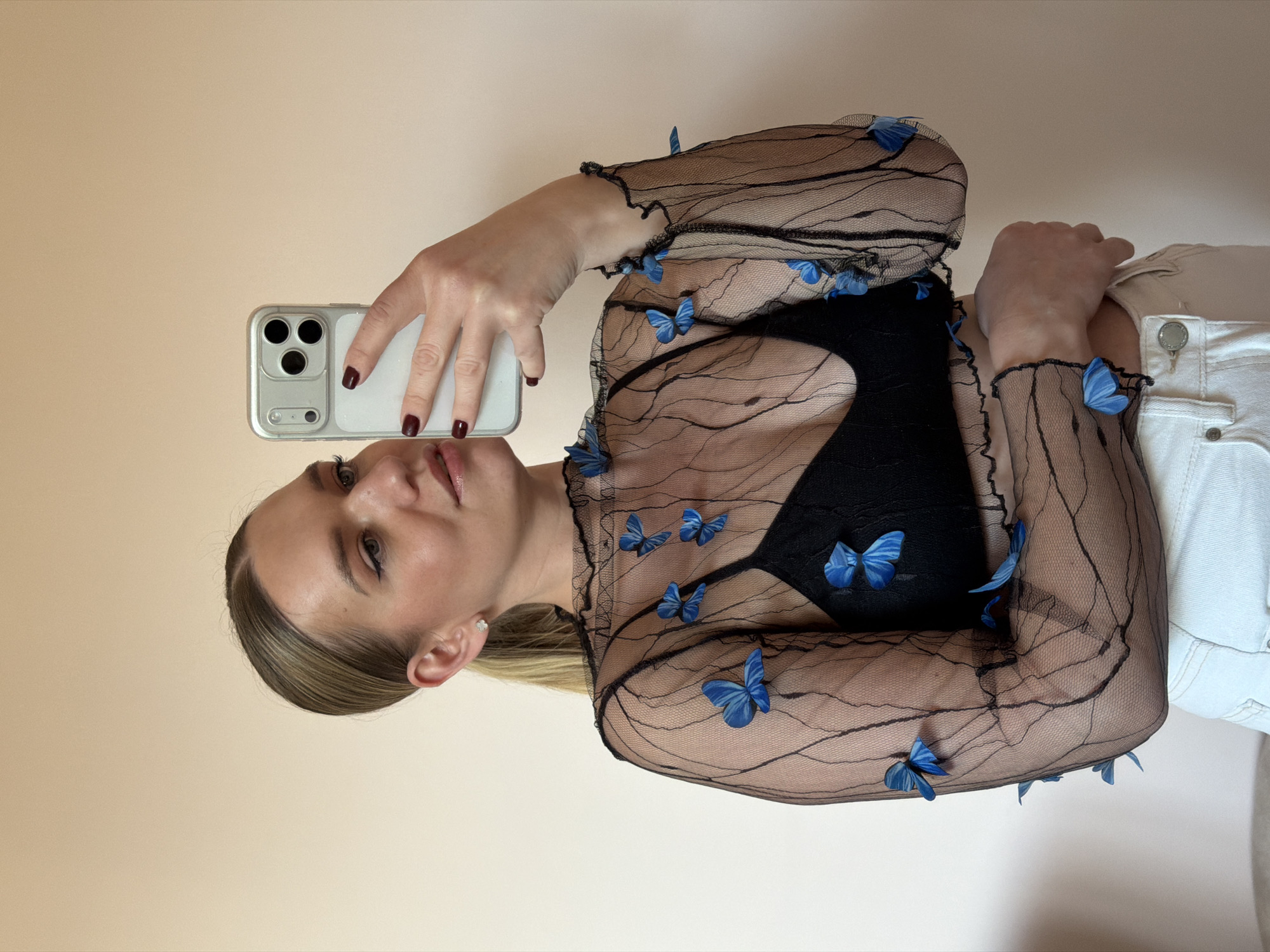 Woman takes mirror selfies in yellow top and sunglasses