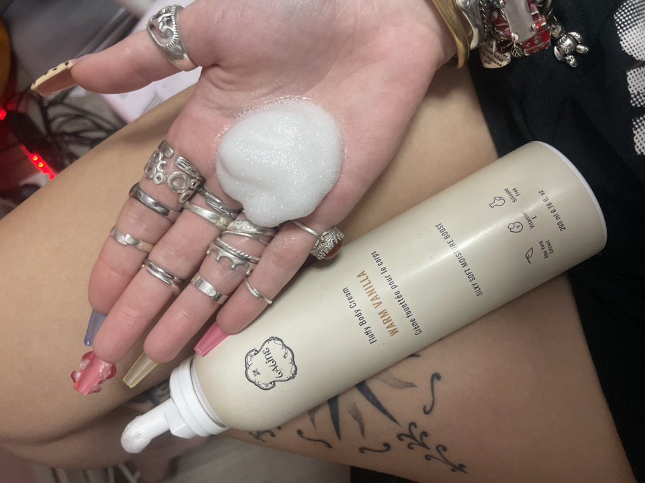 Person documents skincare routine with body cream in Ra'anana