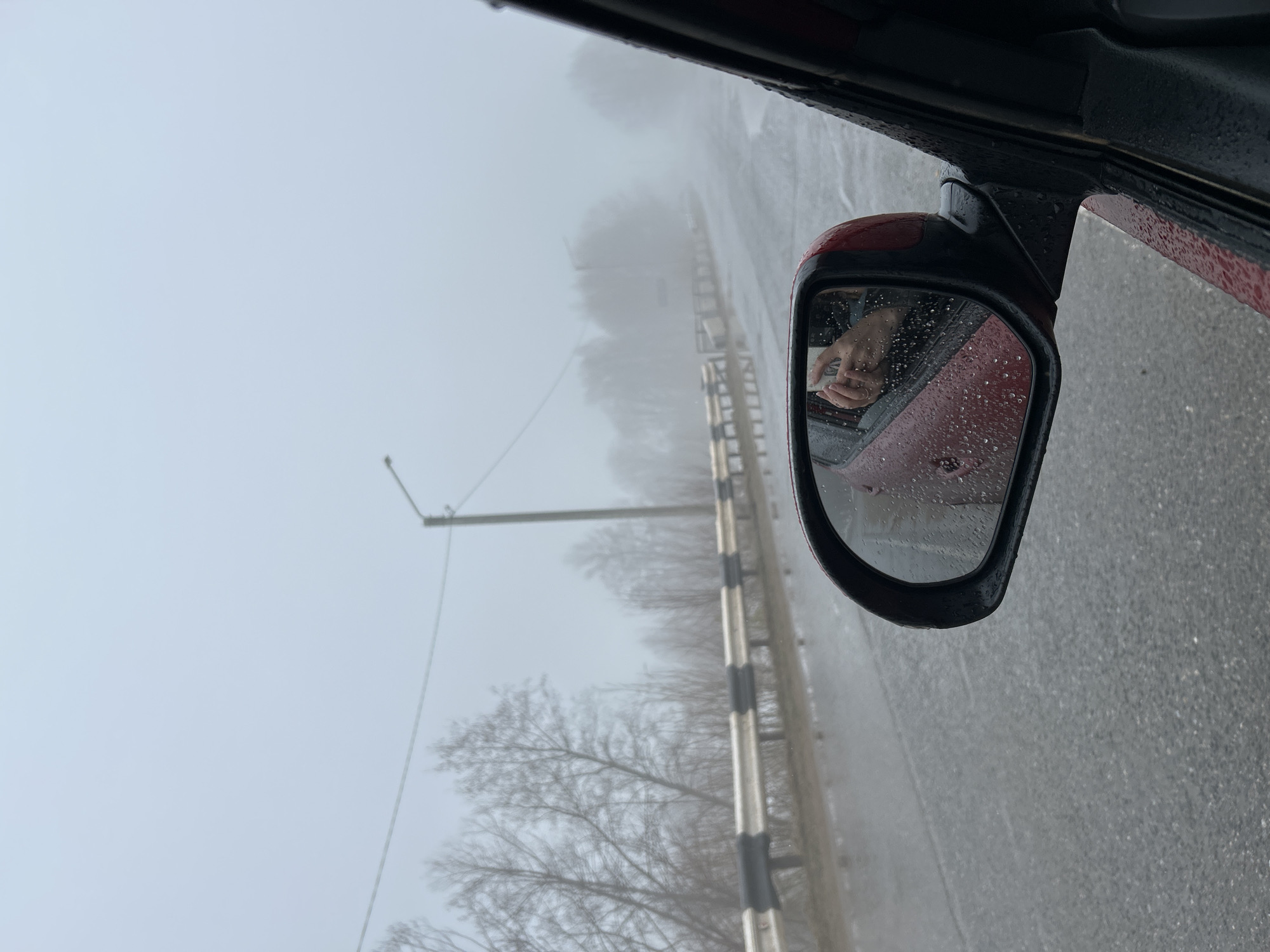 Motorist documents foggy morning drive through Уральское, Russia