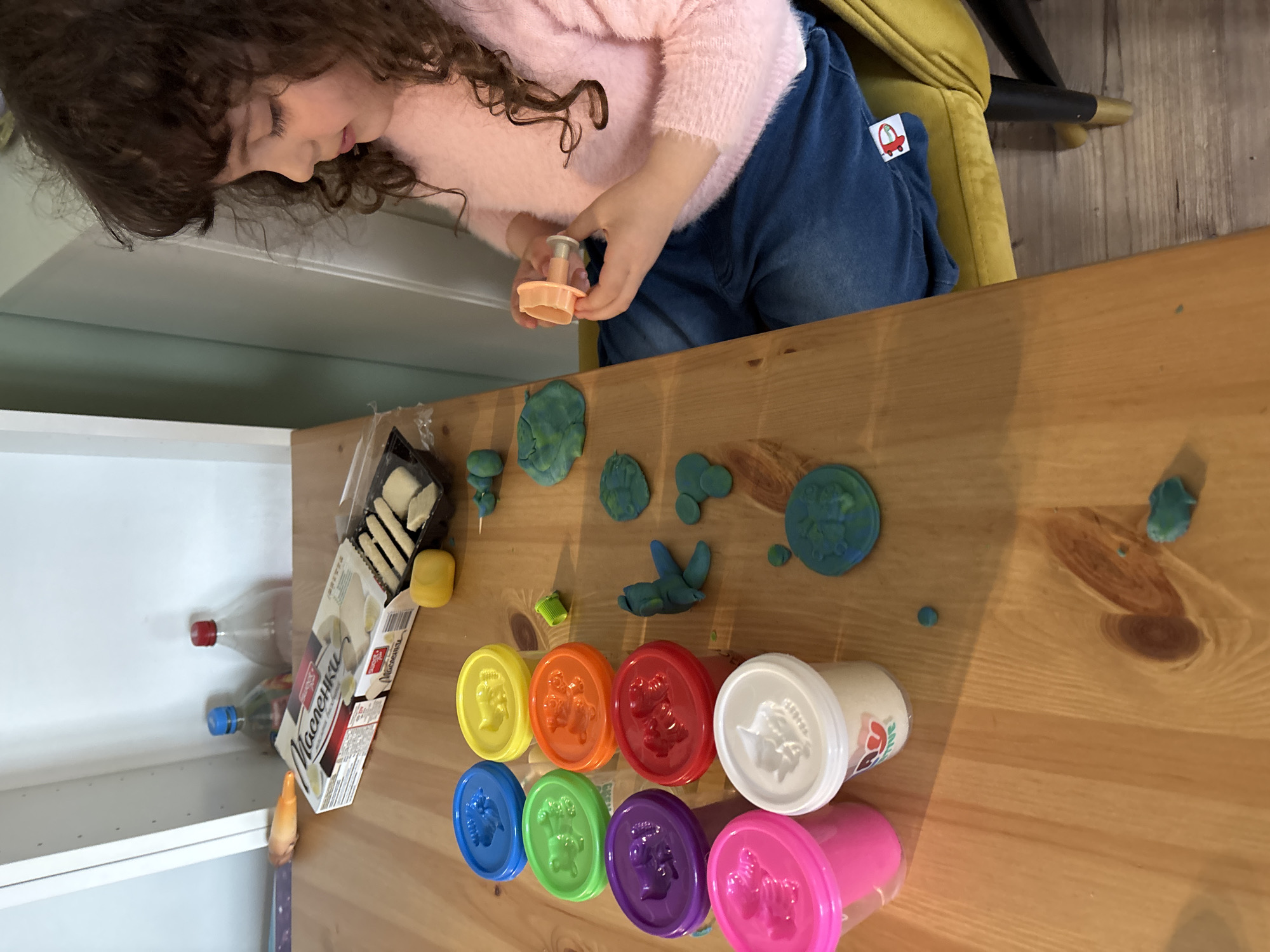 Child plays with Play-Doh at table in Sofia