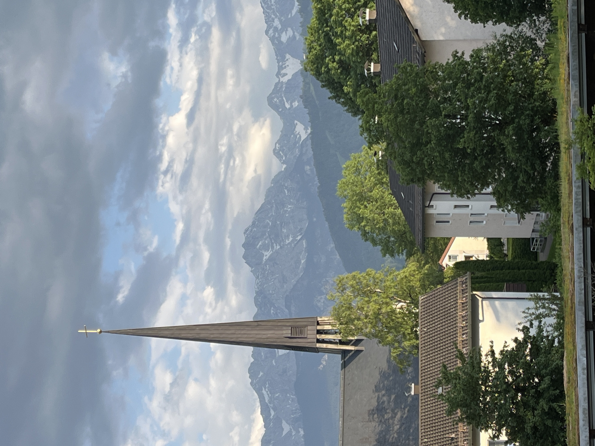 Church steeple and Alpine peaks captured in Garmisch-Partenkirchen