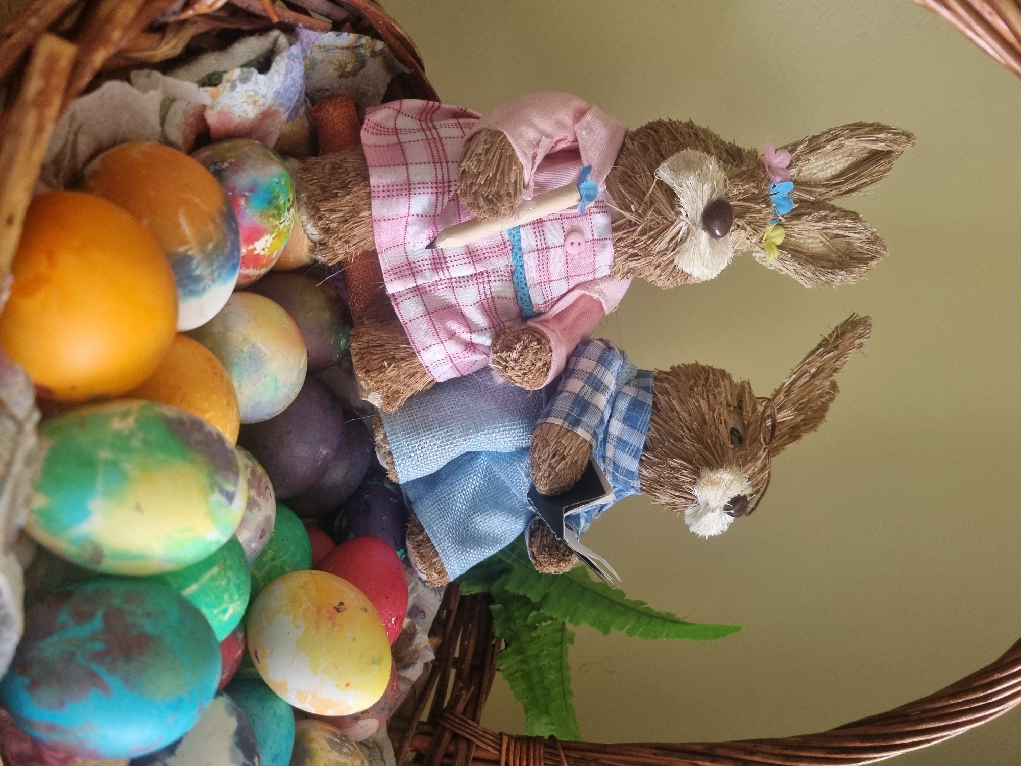 Easter basket with colorful eggs and bunny figurines observed