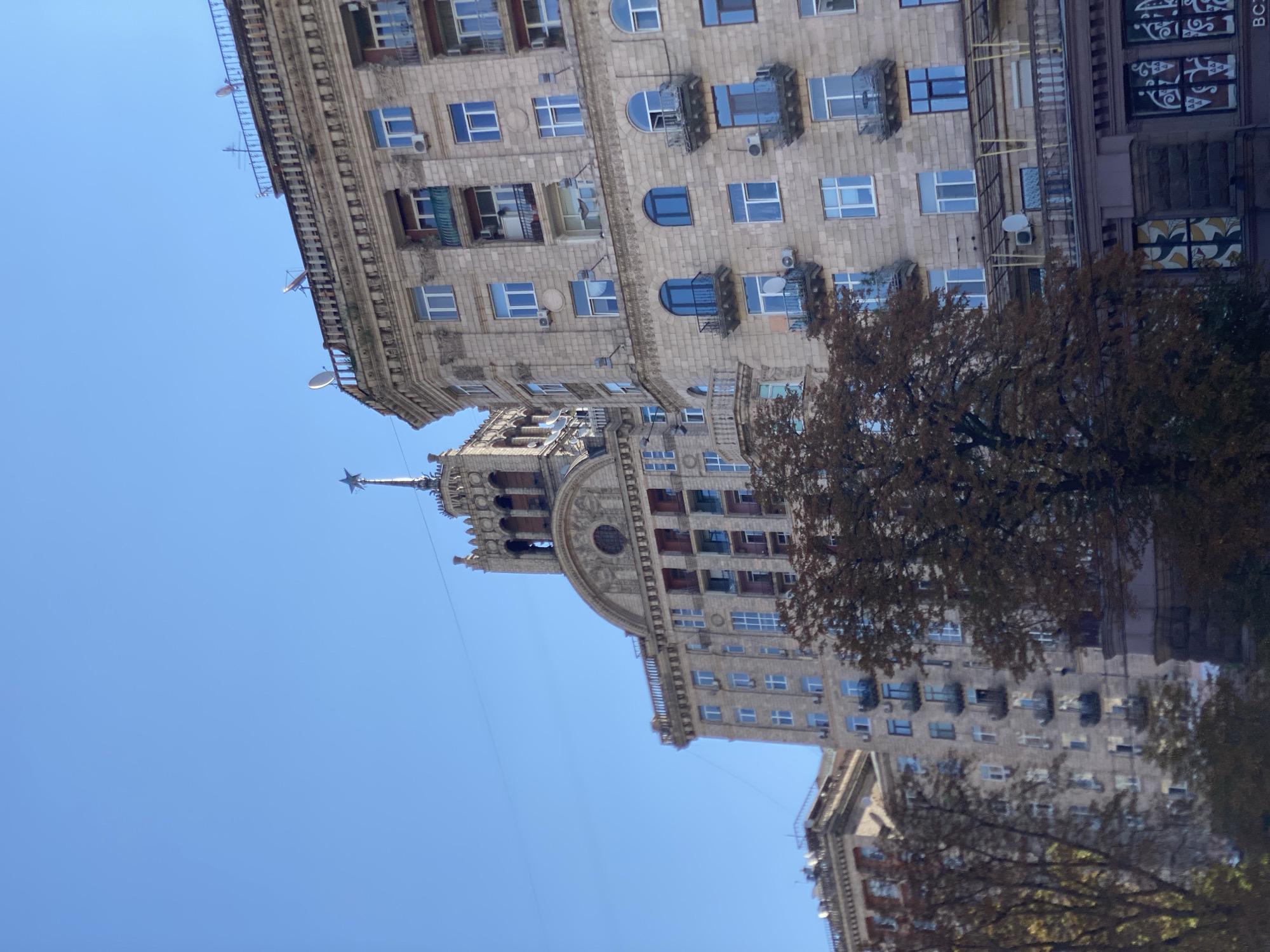 Stalinist-era skyline with Ukrainian flag on a sunny morning