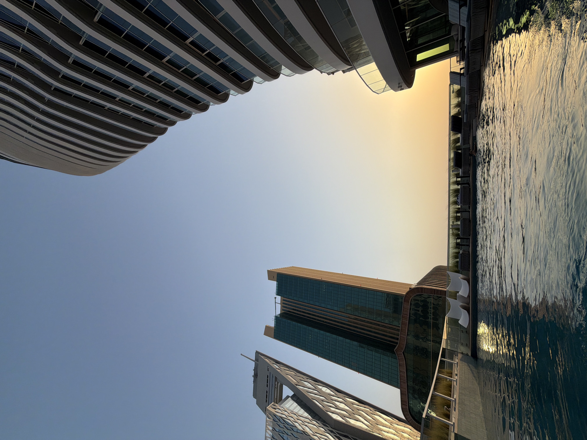 Lusail rooftop pool at sunset, skyline views and city streets
