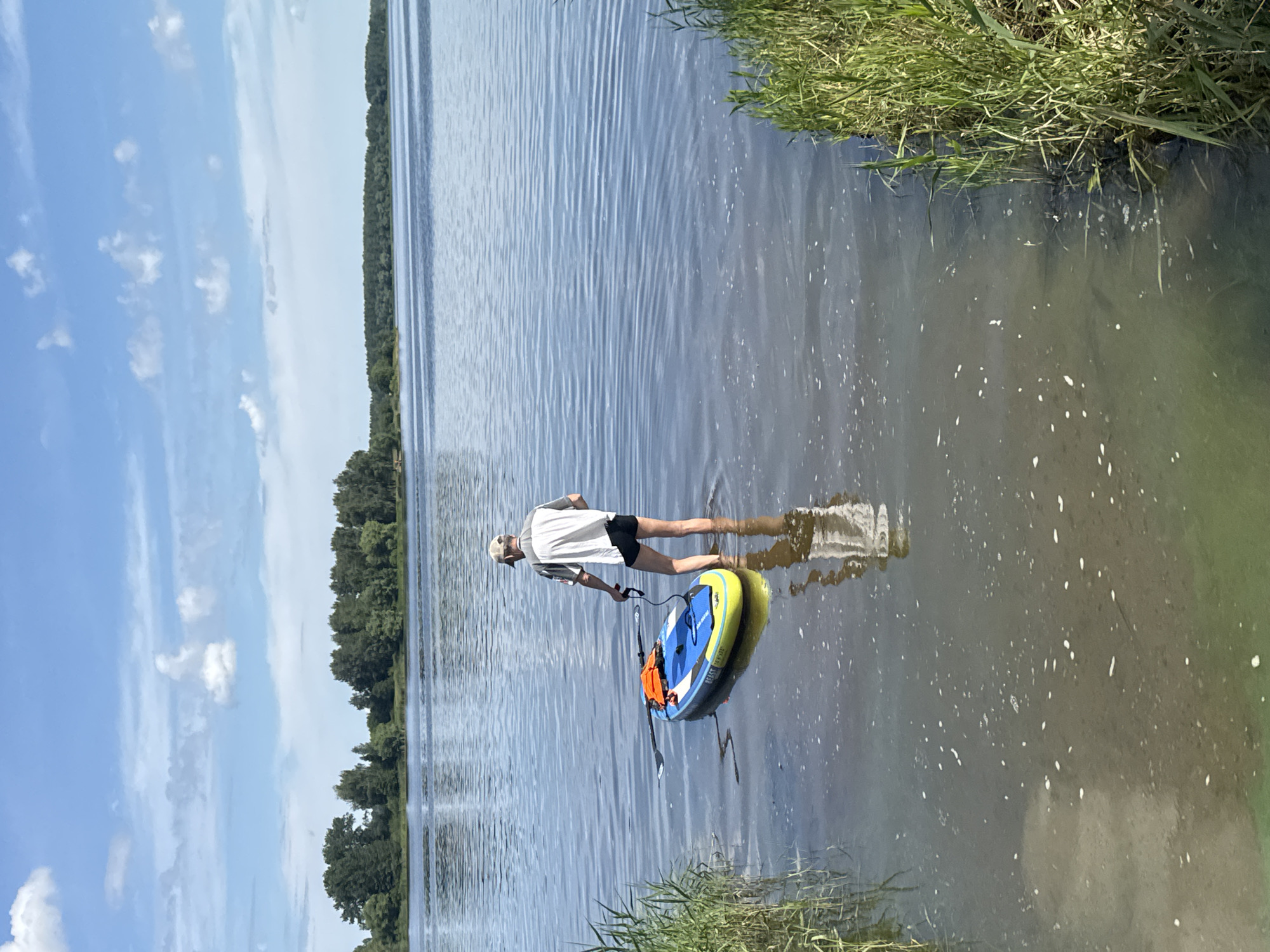 Stand-up paddleboarding on calm open water at dawn
