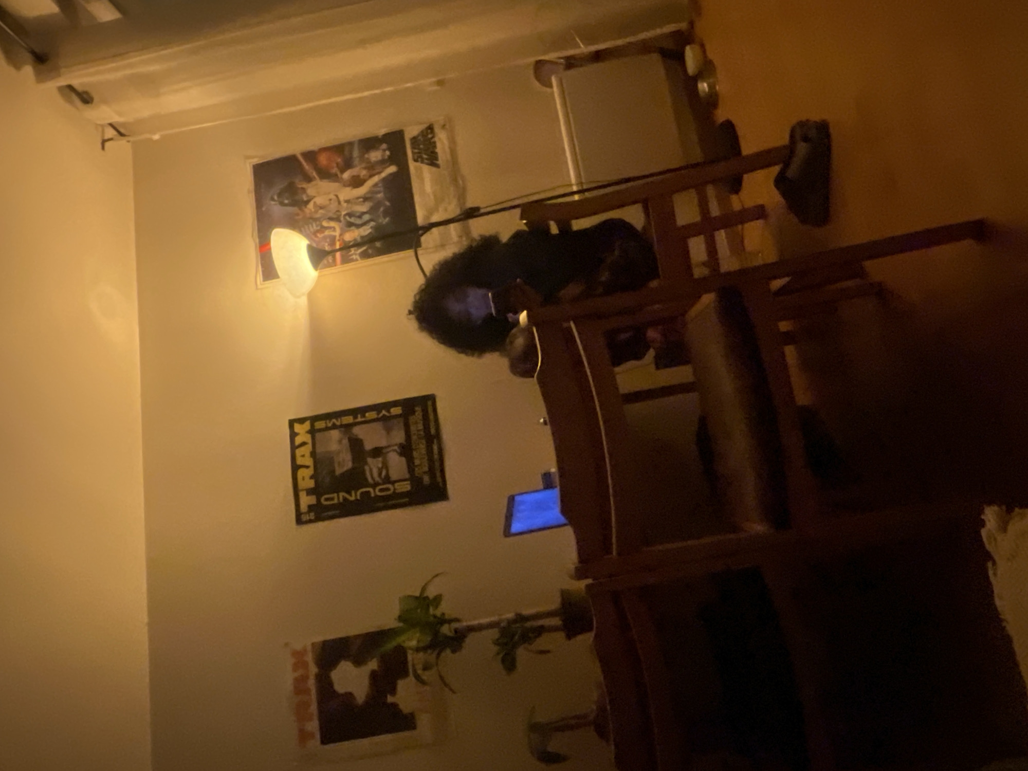Person sits at desk in dimly lit Aubervilliers room