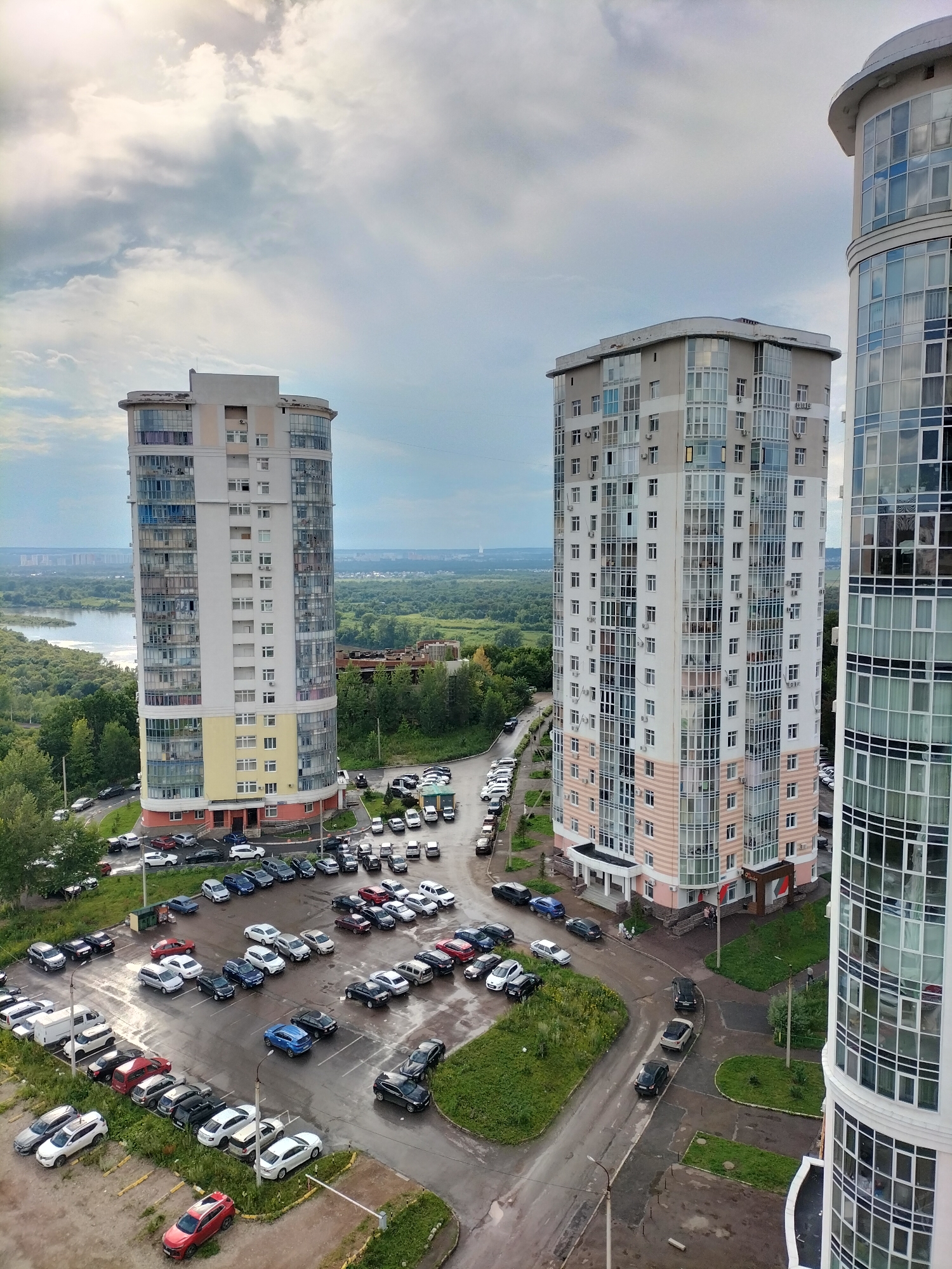 Aerial views contrast city high-rises with a forested river bend