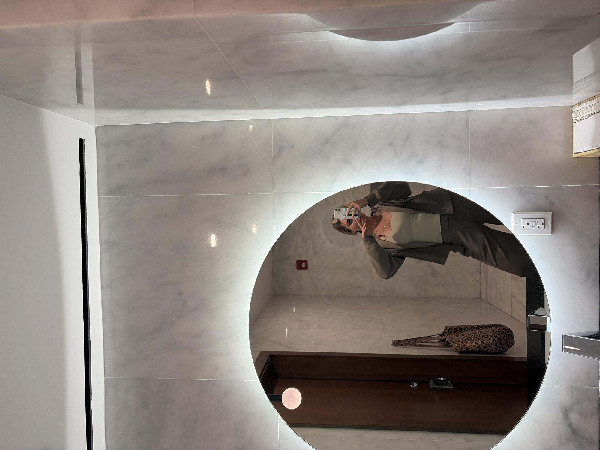 Person Takes Mirror Selfie in Miami Bathroom